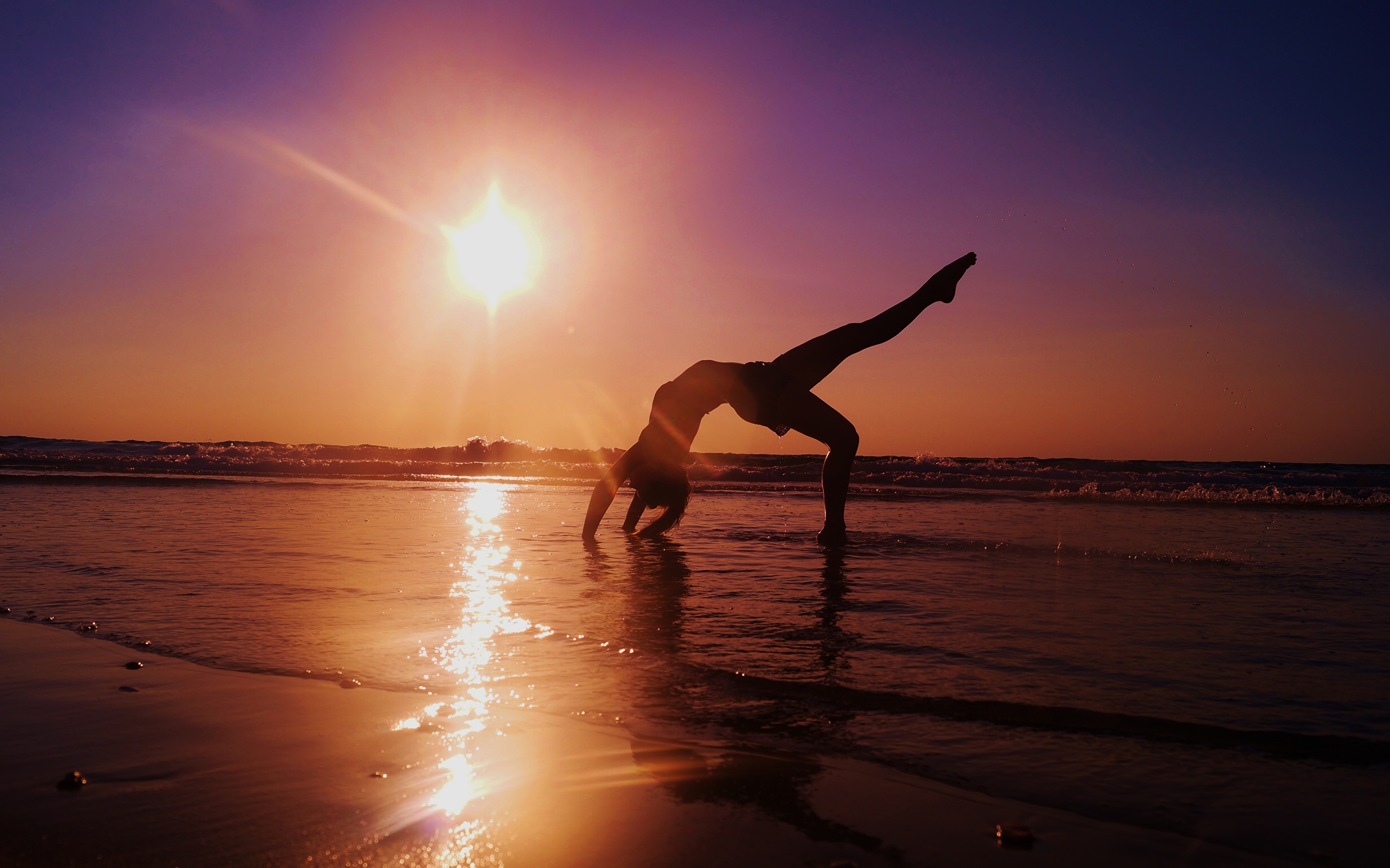 Acrobatic Gymnastics: An amateur stretch performed at the beach, Recreational activity and sport. 2880x1800 HD Background.