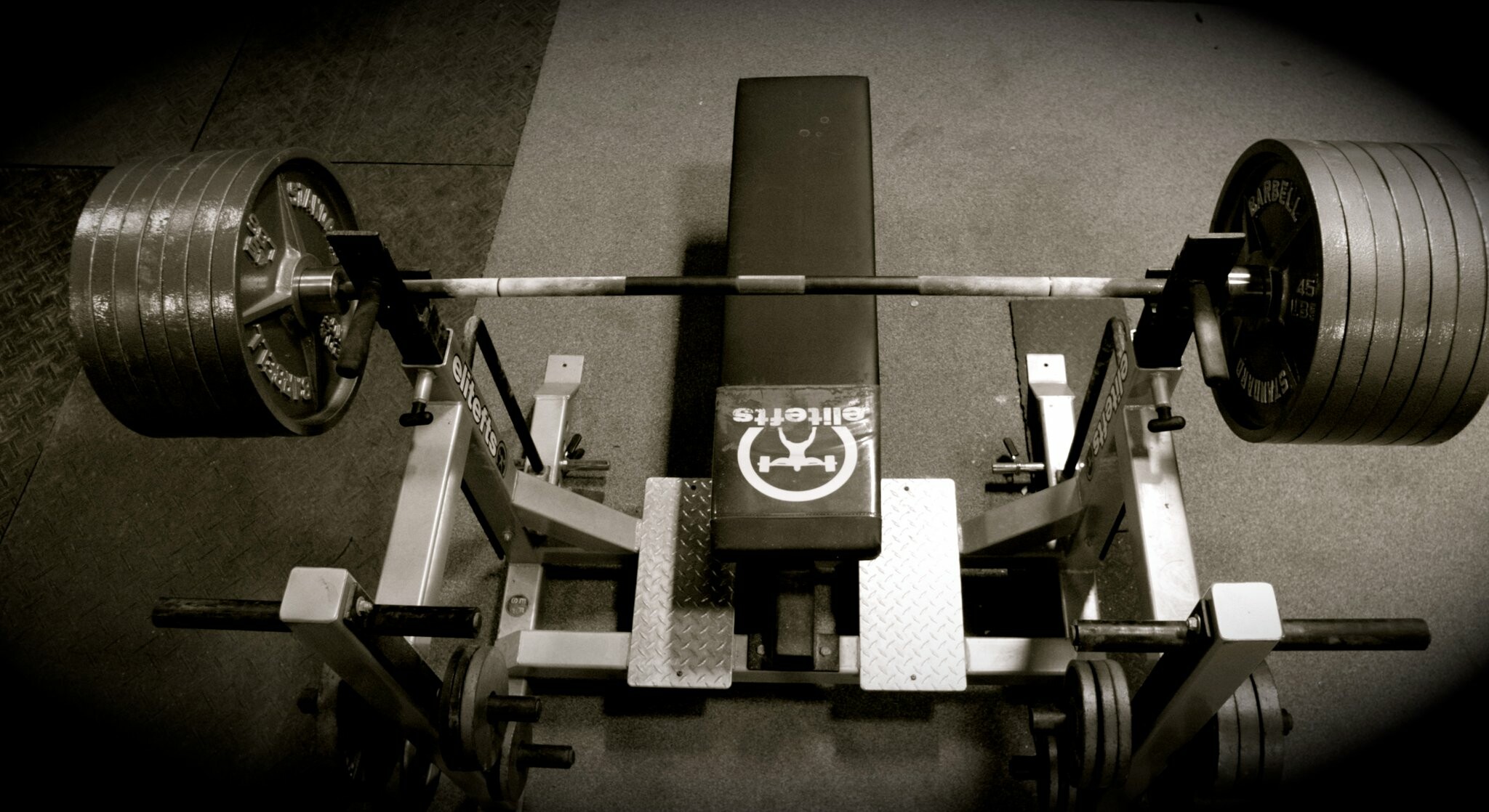 Powerlifting: A barbell loaded with weight plates, Weightlifting. 2050x1120 HD Background.
