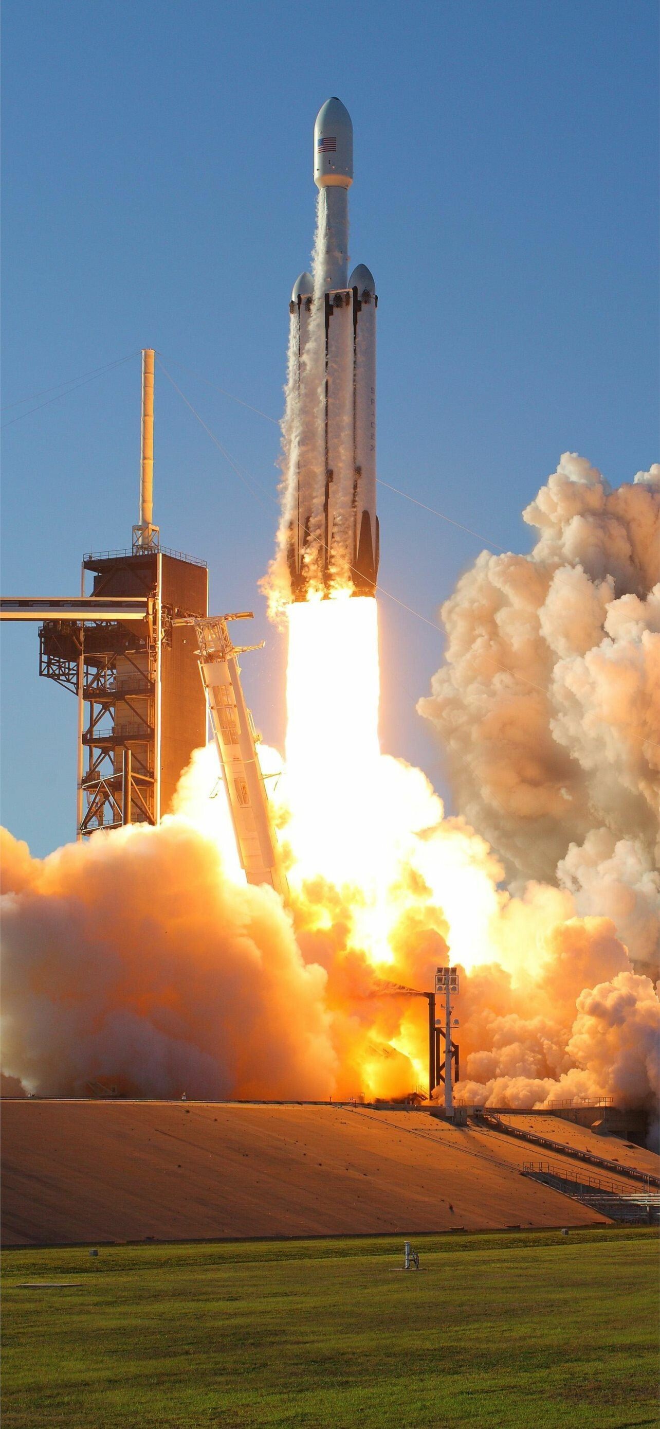 SpaceX: The company designs, manufactures and launches the world's most advanced rockets. 1290x2780 HD Background.