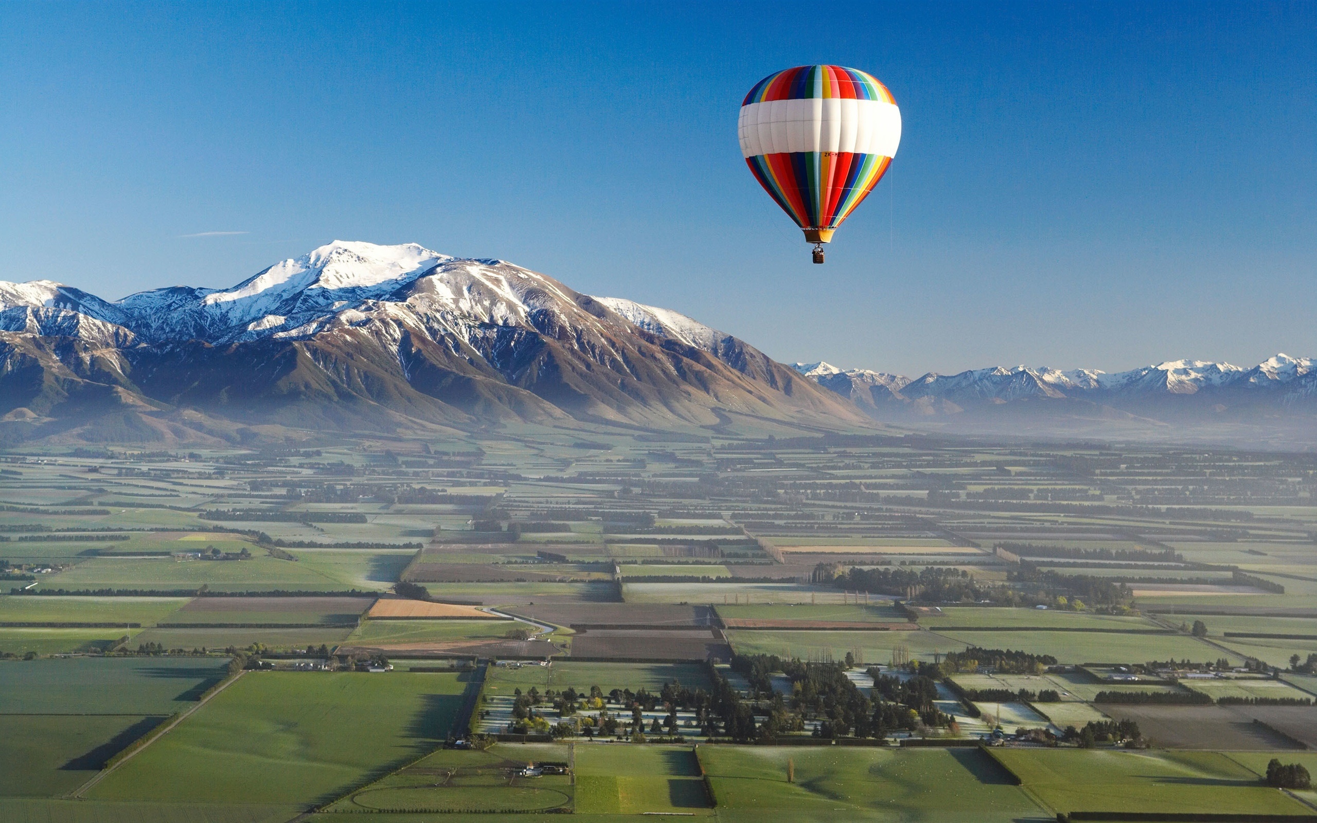Air Sports: Balloon ride over the snow mountain chain and the village, Balloon travel. 2560x1600 HD Wallpaper.