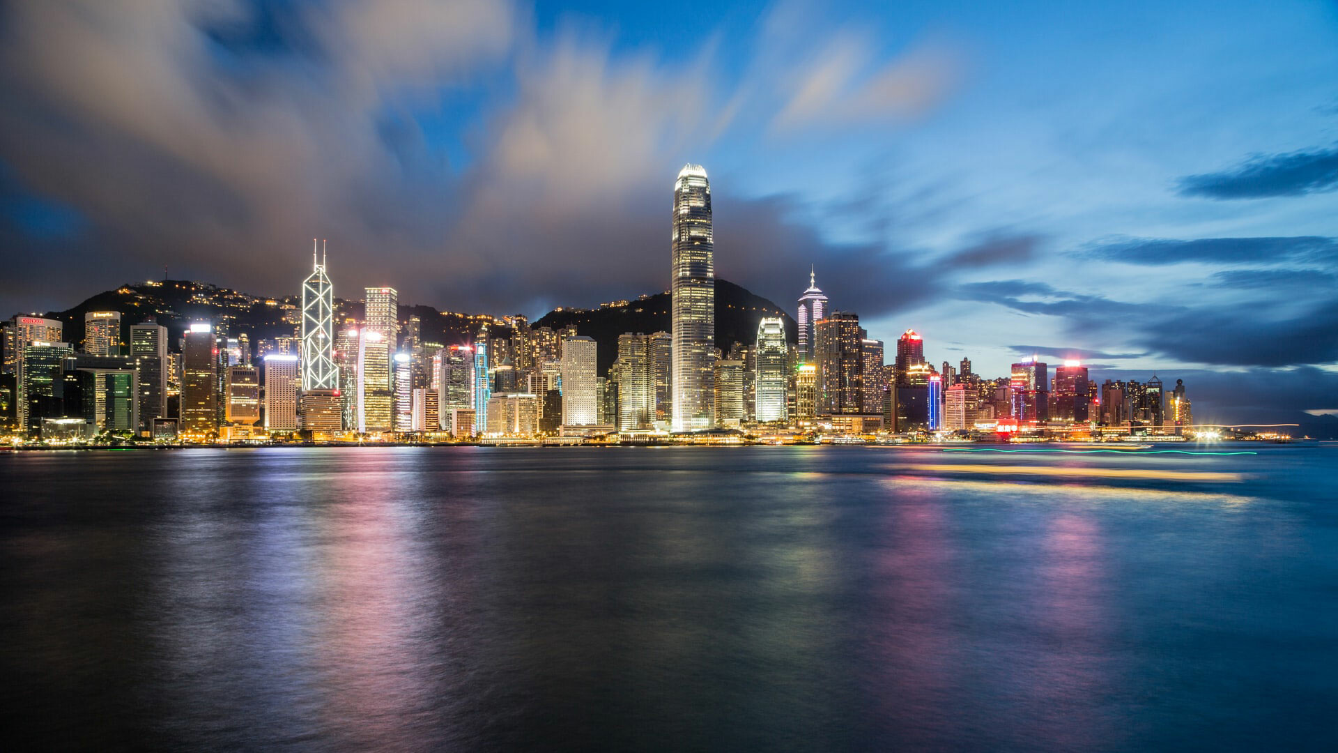 Hong Kong: Hong Kong's Central and Western District skyline at dawn, viewed from Tsim Sha Tsui, on the opposite side of Victoria Harbour, with the skyscraper of the International Finance Centre, Hong Kong's second-highest building in the center. 1920x1080 Full HD Background.