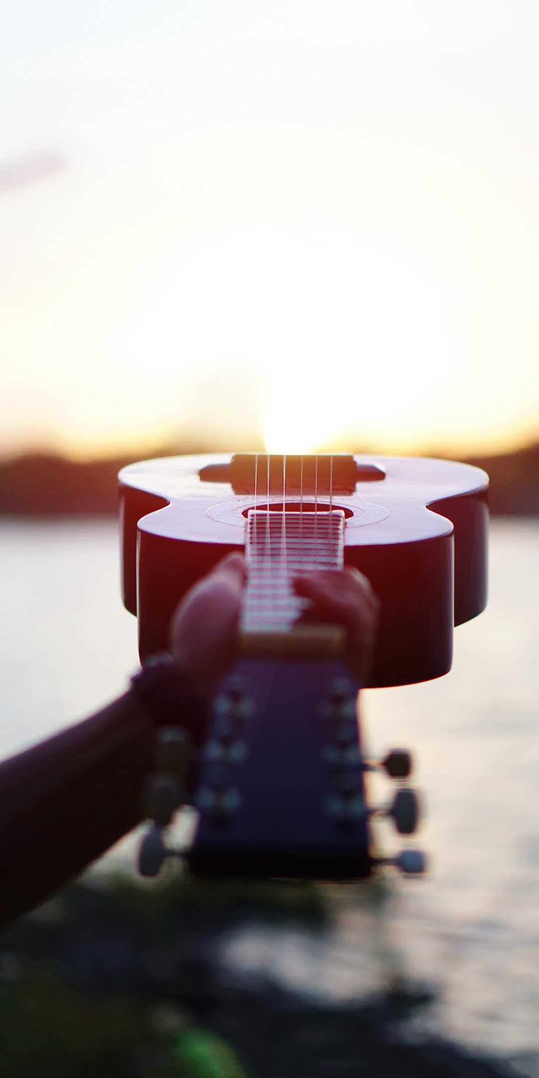 Guitar: A musical instrument with a flat-backed rounded body that narrows in the middle. 1080x2160 HD Background.