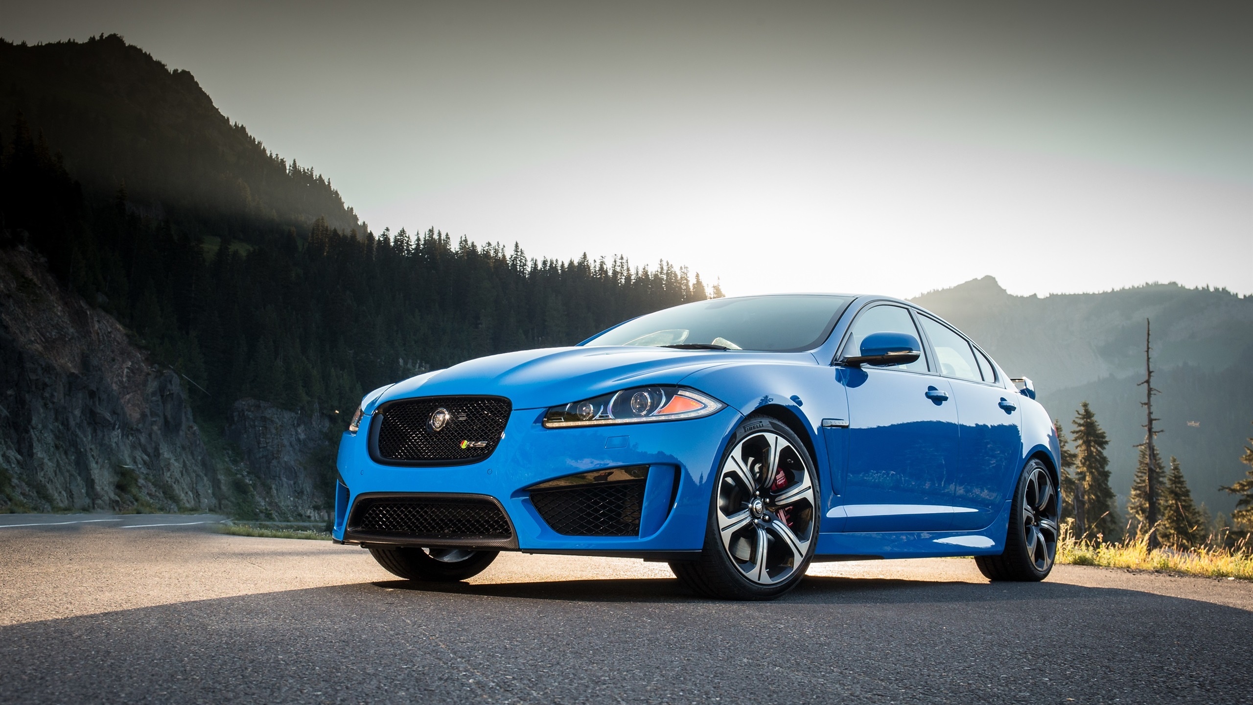 Jaguar car, Nature backdrop, Headlights and tires, Mountainous terrain, 2560x1440 HD Desktop