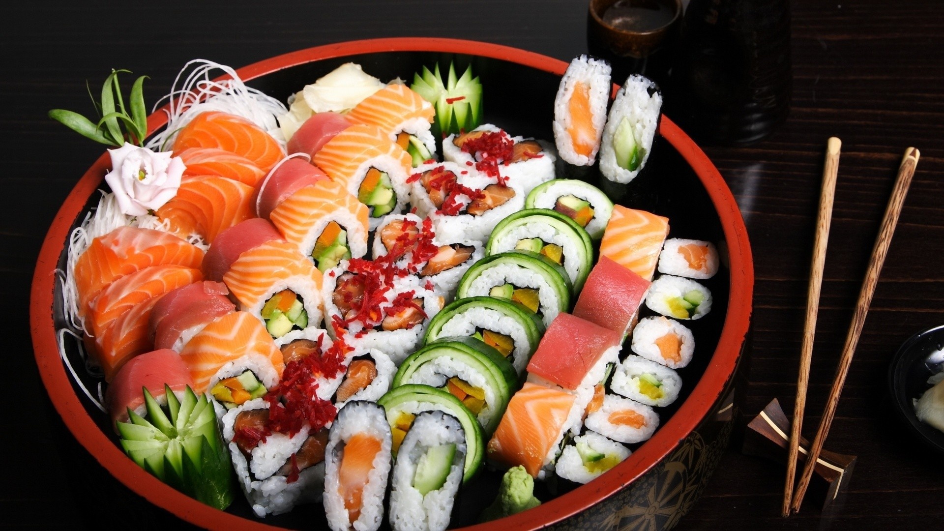 Sushi: Japanese meal comprising vinegared rice, seafood, fish, vegetables, and seaweed. 1920x1080 Full HD Background.