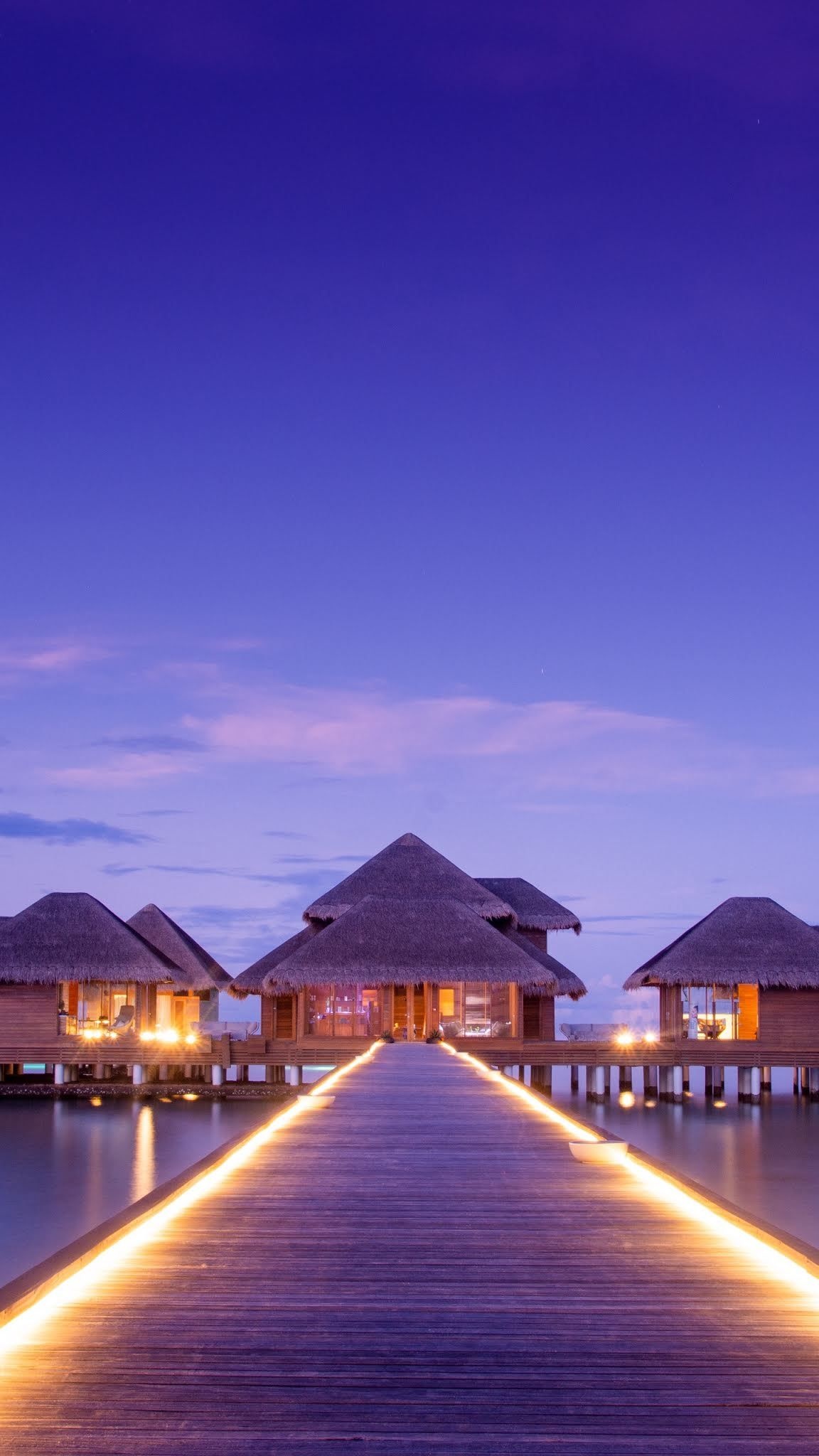 Bungalow: A group of overwater beach houses, Popular resort, Ocean coast during the sunset. 1160x2050 HD Background.