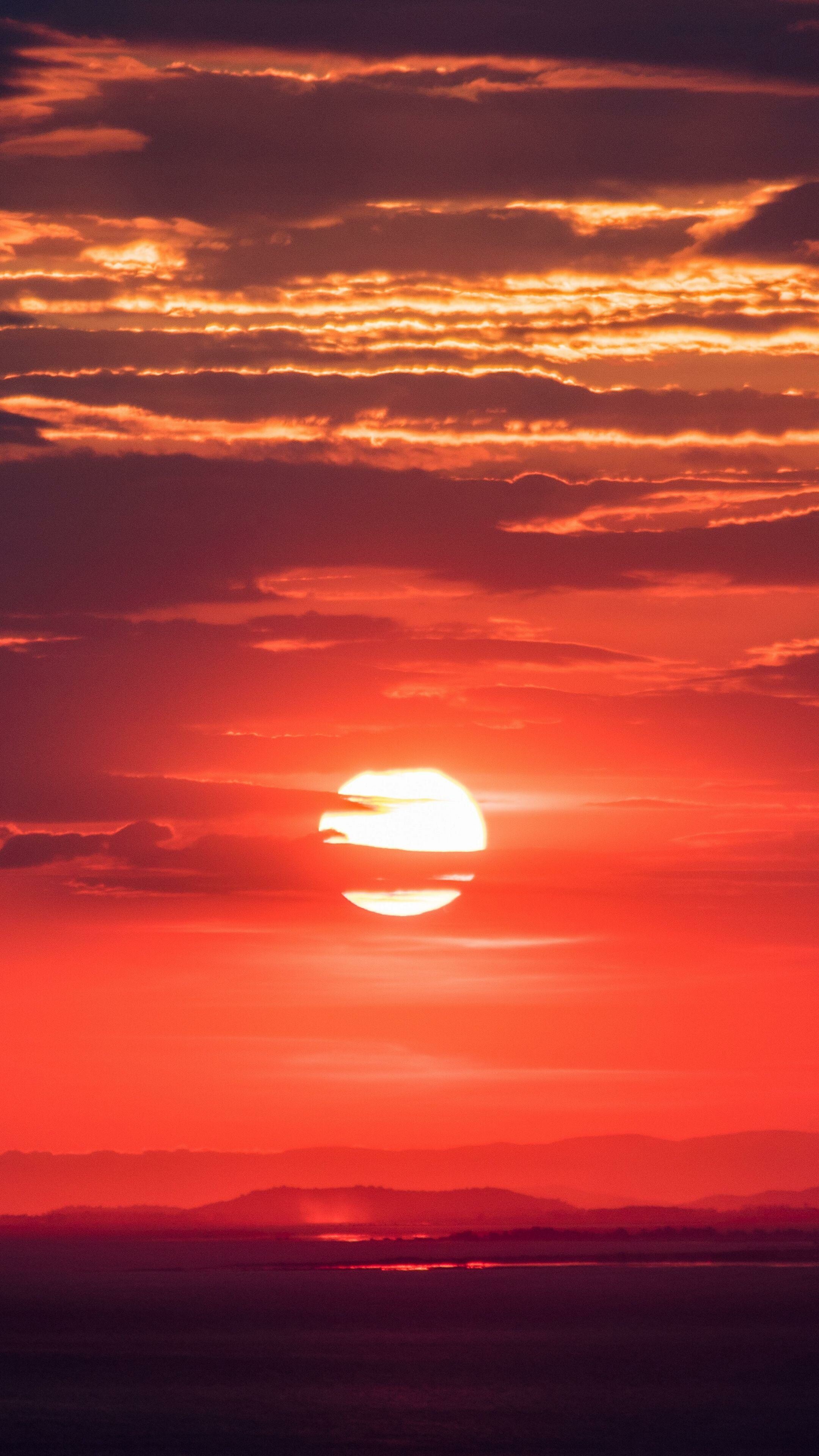 Sunset: The time in the evening when you last see the sun in the sky, Solar disk. 2160x3840 4K Background.