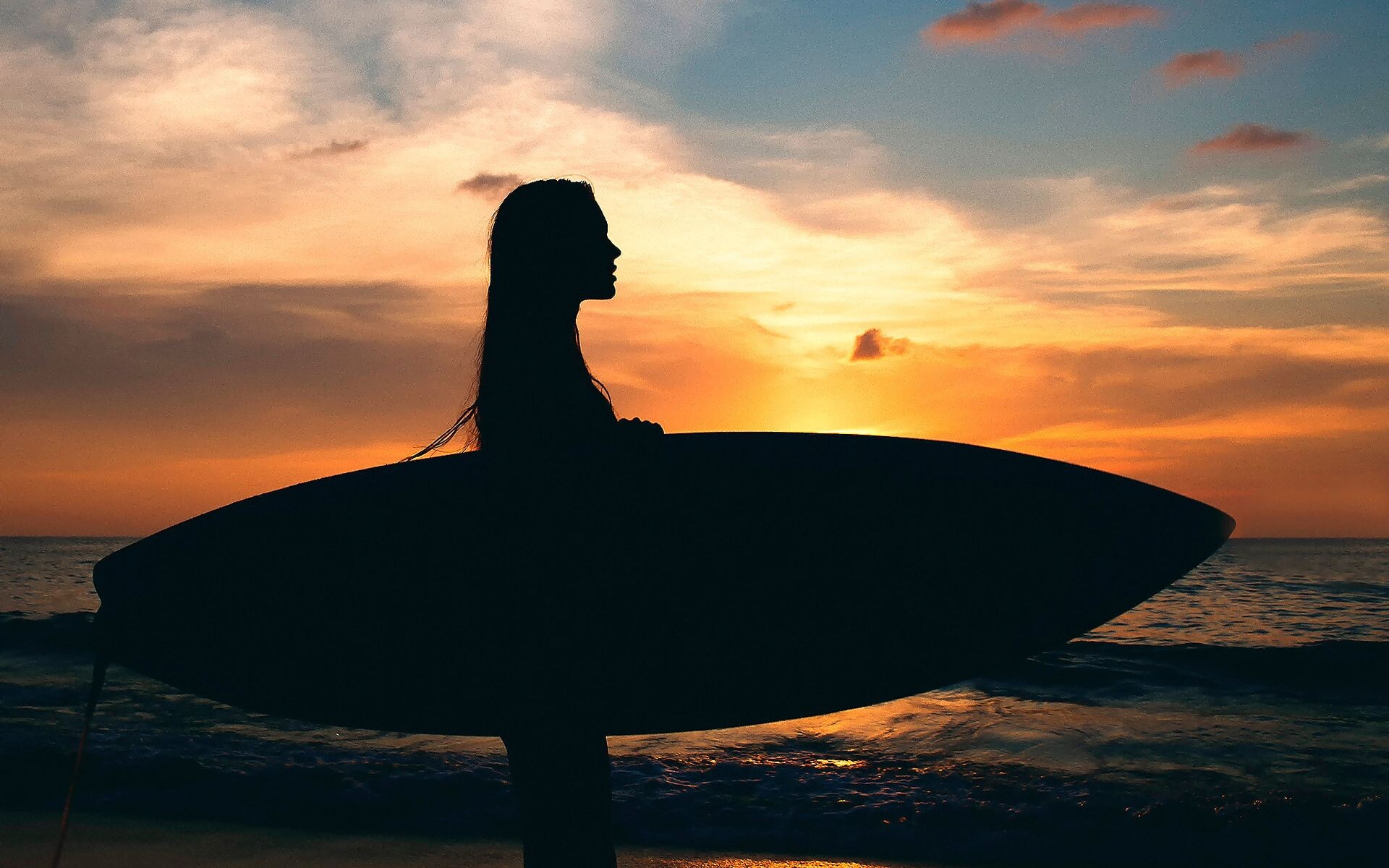 Girl Surfing: Outdoor vacation activity, Riding the waves off the shore at sunset, Surfboards for women. 1920x1200 HD Wallpaper.