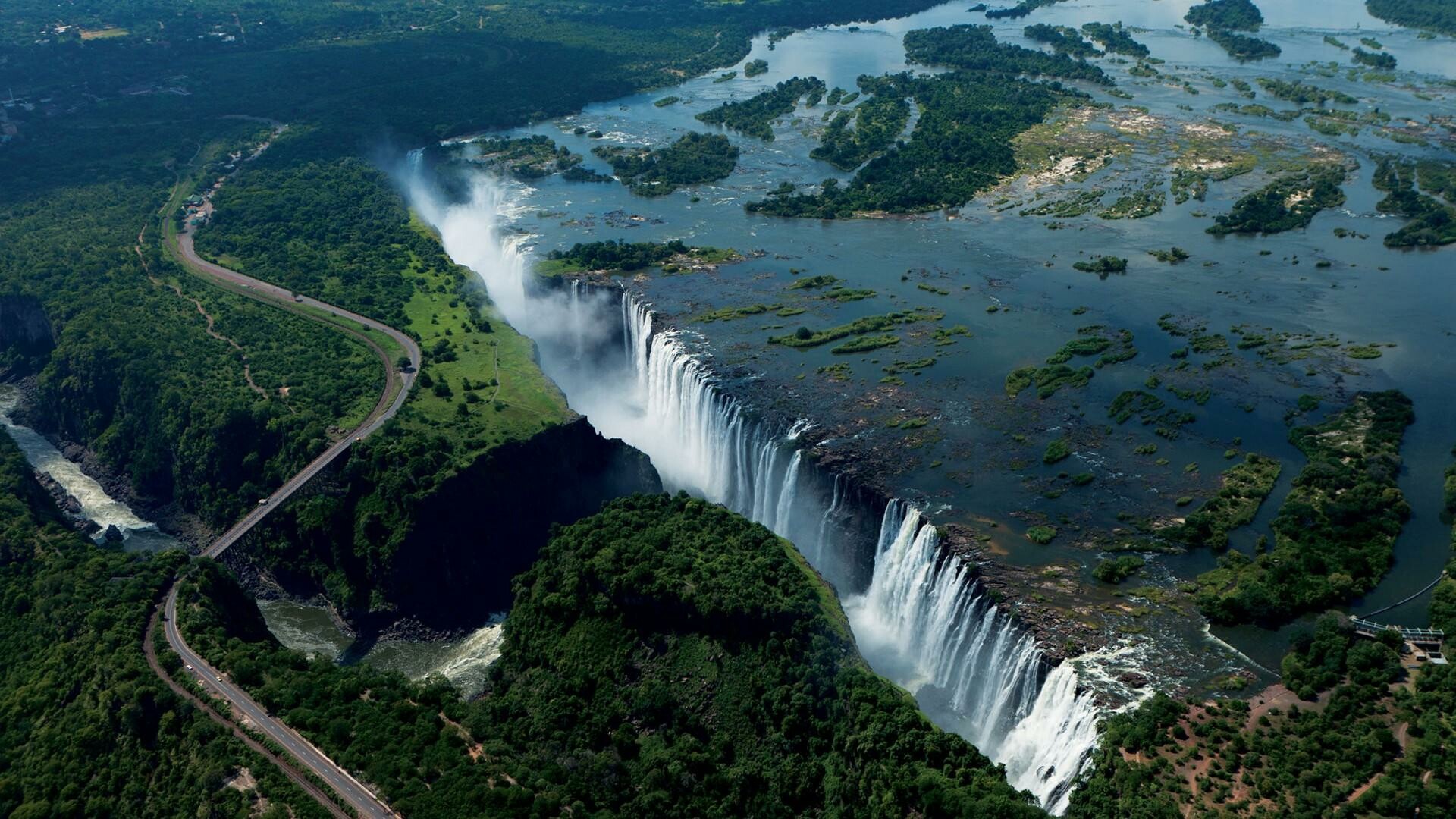 Victoria Falls: A UNESCO Heritage Site, The largest single sheet of flowing water in the world. 1920x1080 Full HD Wallpaper.