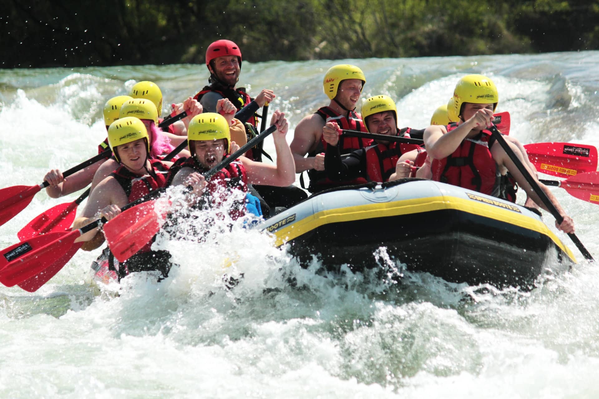 Rafting: Tourists have fun during their maneuvering over intense rapids. 1920x1280 HD Background.