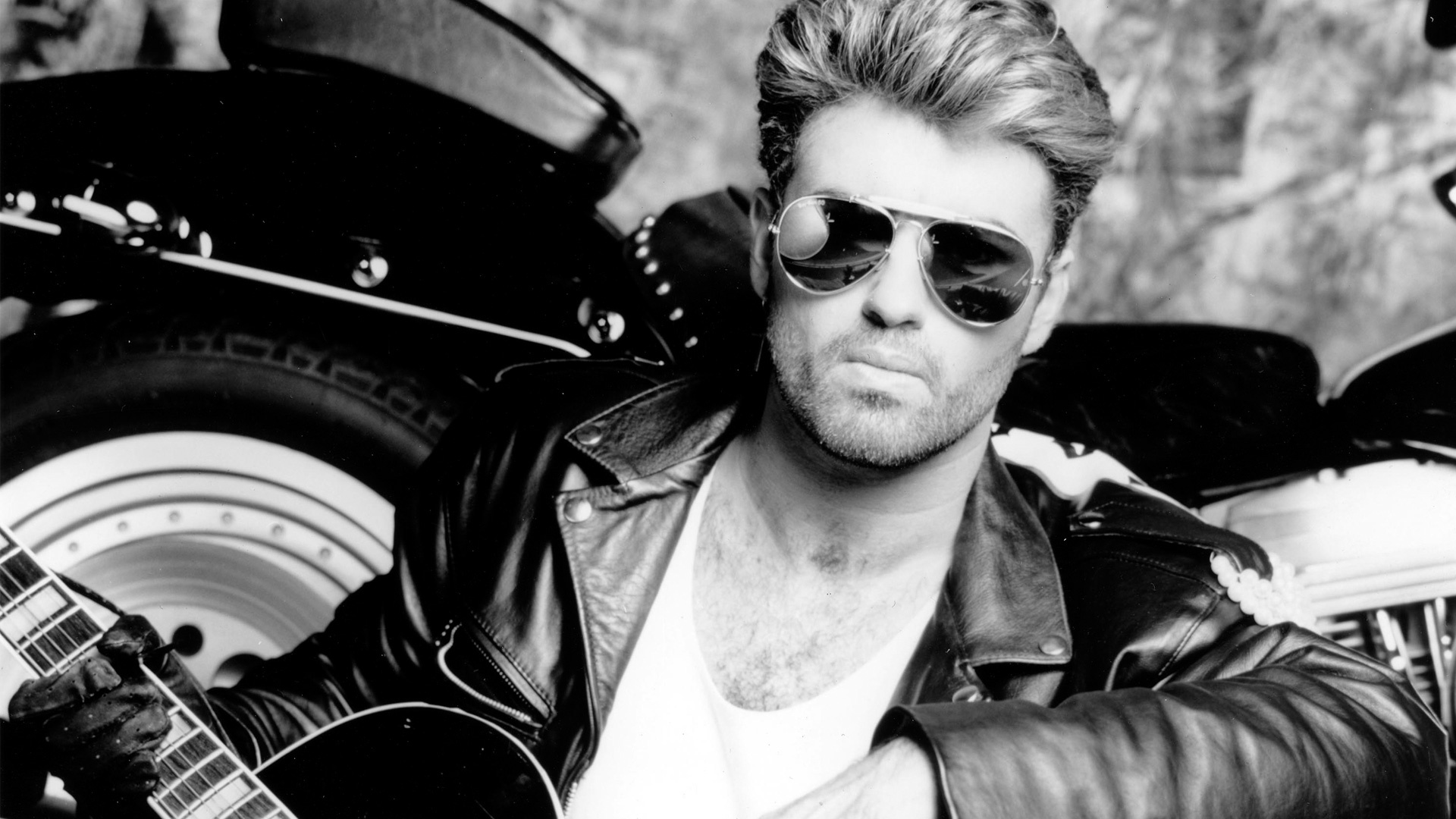 George Michael: A ground-breaking British pop artist who has sold more than 120 million records worldwide. 1920x1080 Full HD Background.