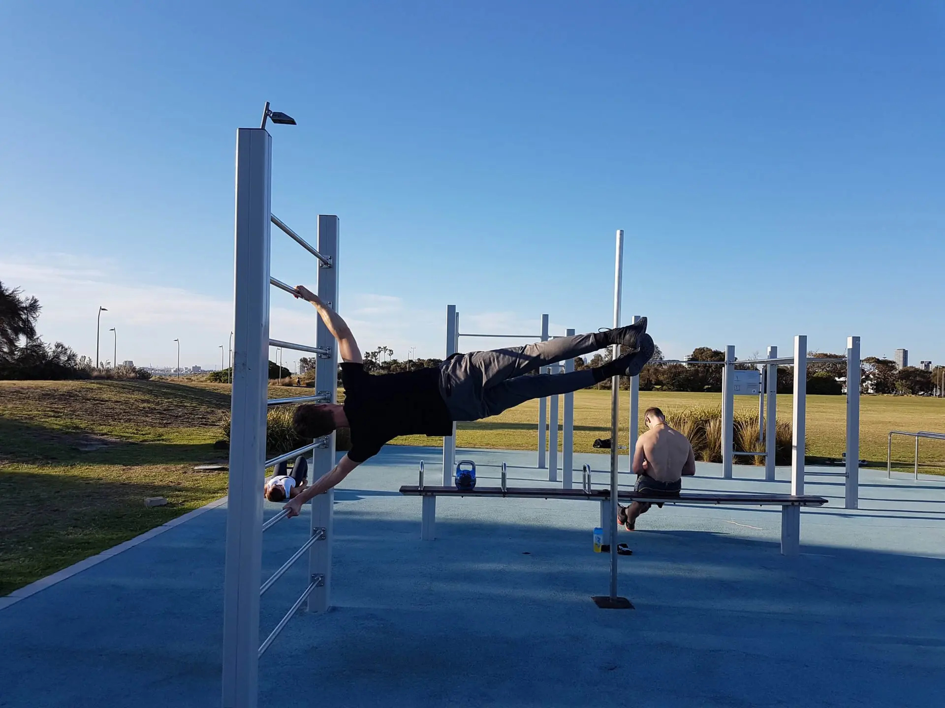 Calisthenics: A bar hold exercise, A strength exercise where the body is parallel to the ground supported by a vertical bar. 1920x1440 HD Background.