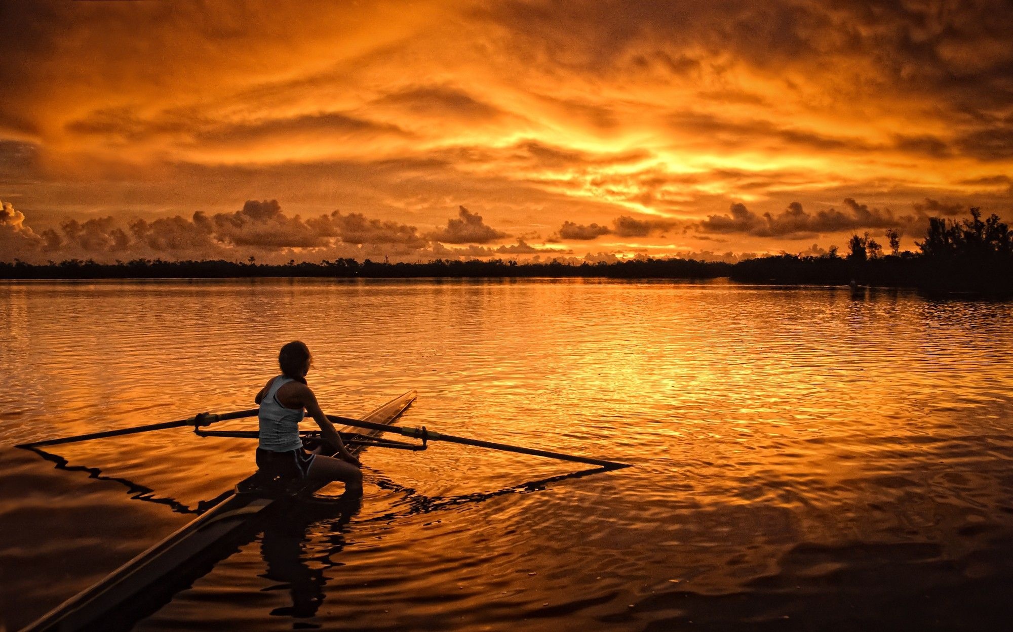 Rowing: Recreational boating, A female sculler looks at an amazing sunset, A water sports discipline. 2000x1250 HD Wallpaper.