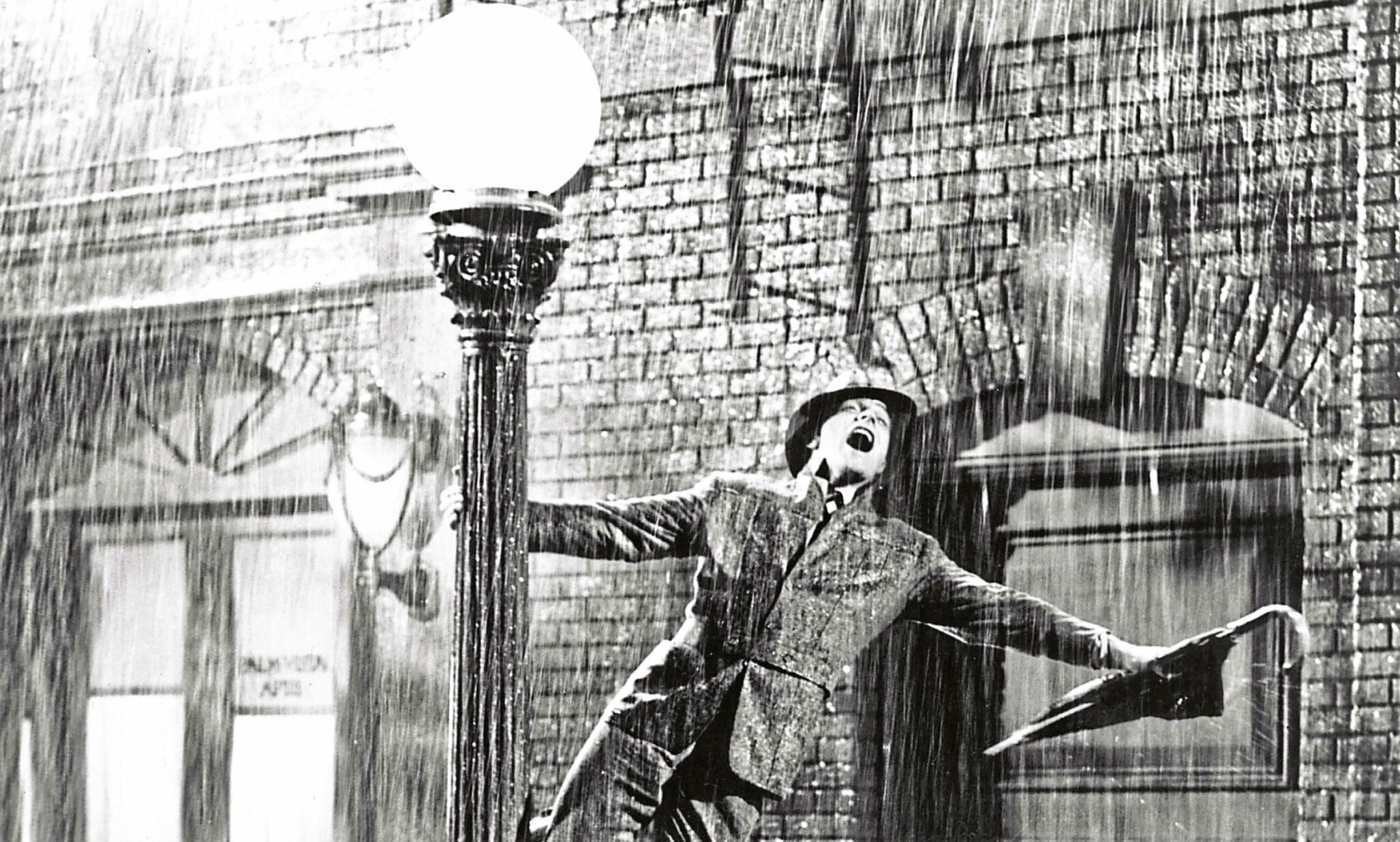 Singin' in the Rain: Gene Kelly as Donald (Don) Lockwood, Produced by Arthur Freed. 2060x1240 HD Wallpaper.