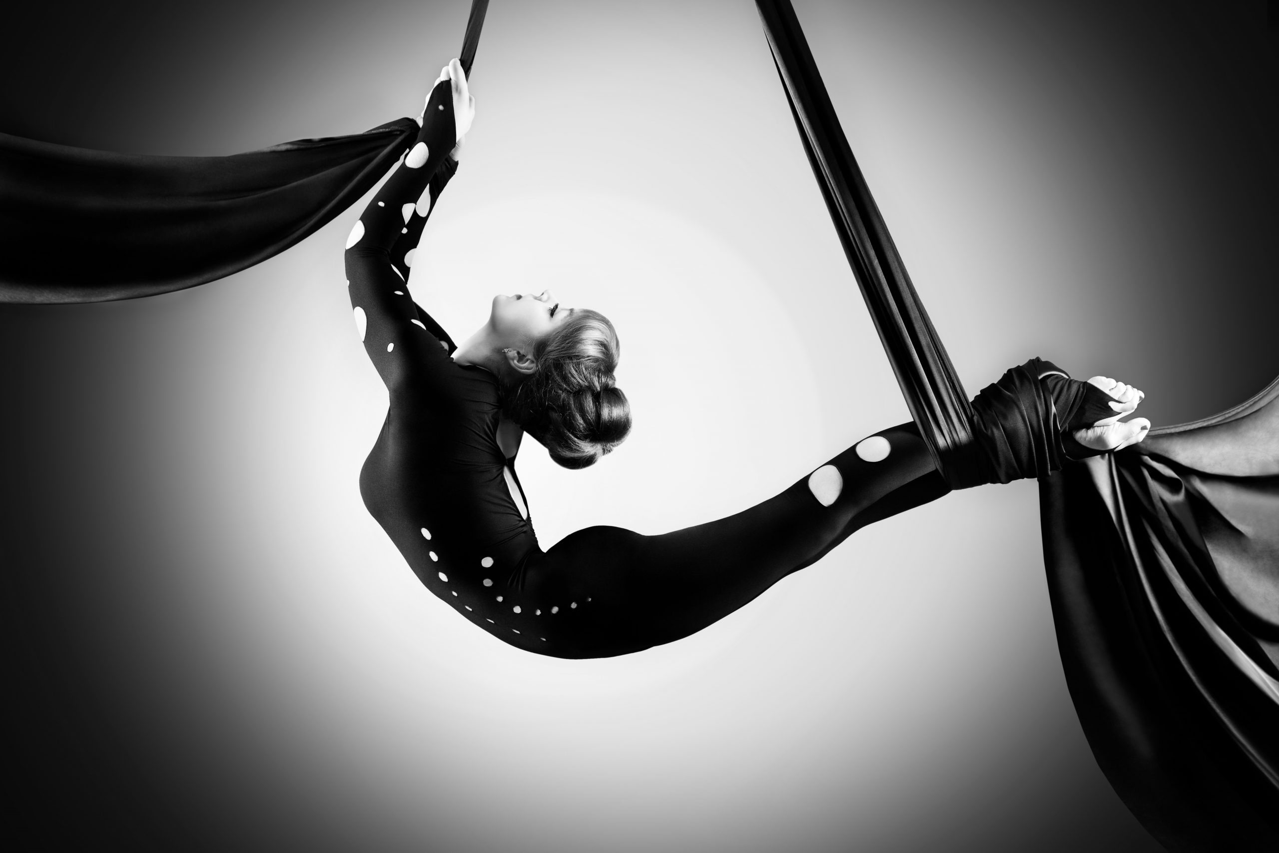 Aerial Silks: A monochrome female dancer performs in the air with the use of fabric. 2560x1710 HD Wallpaper.