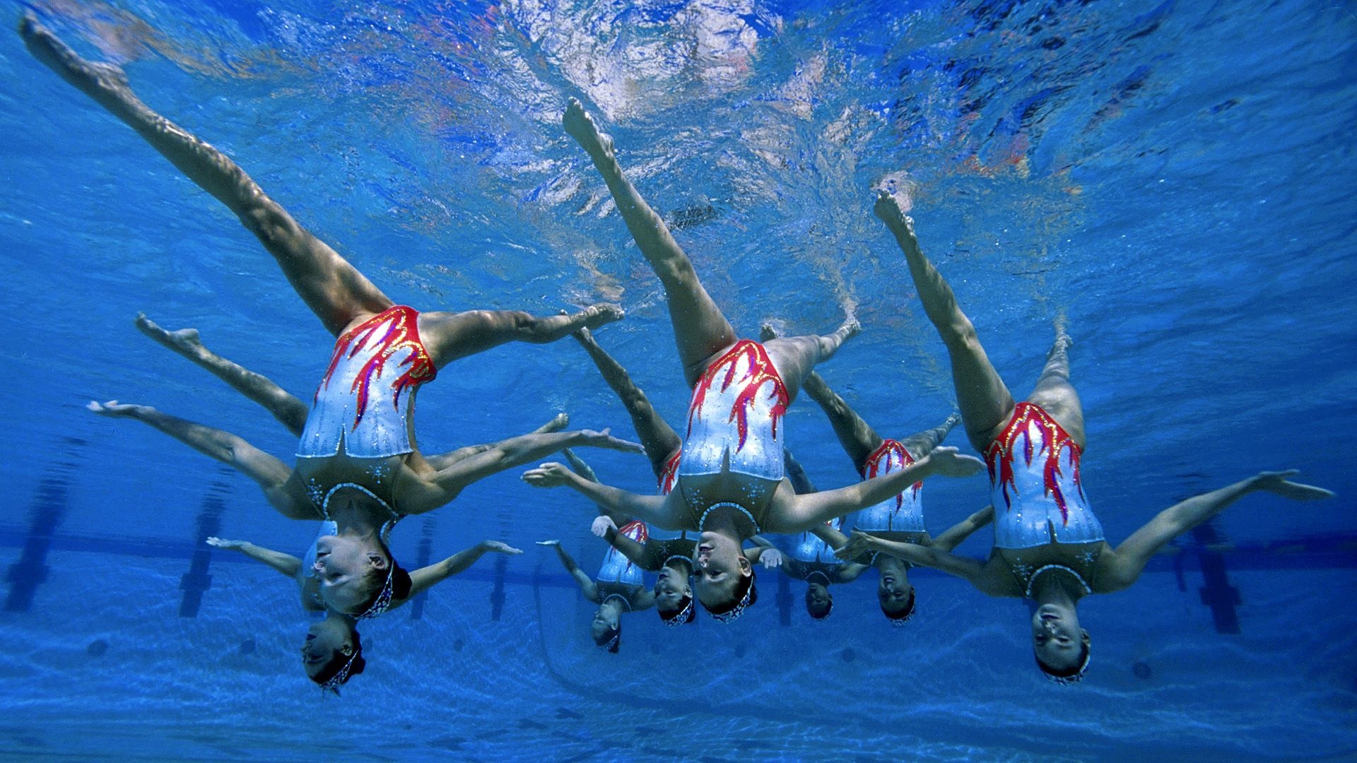 Synchronized Swimming: An underwater ballet, An artistic sports discipline traditionally performed by women. 1920x1080 Full HD Background.
