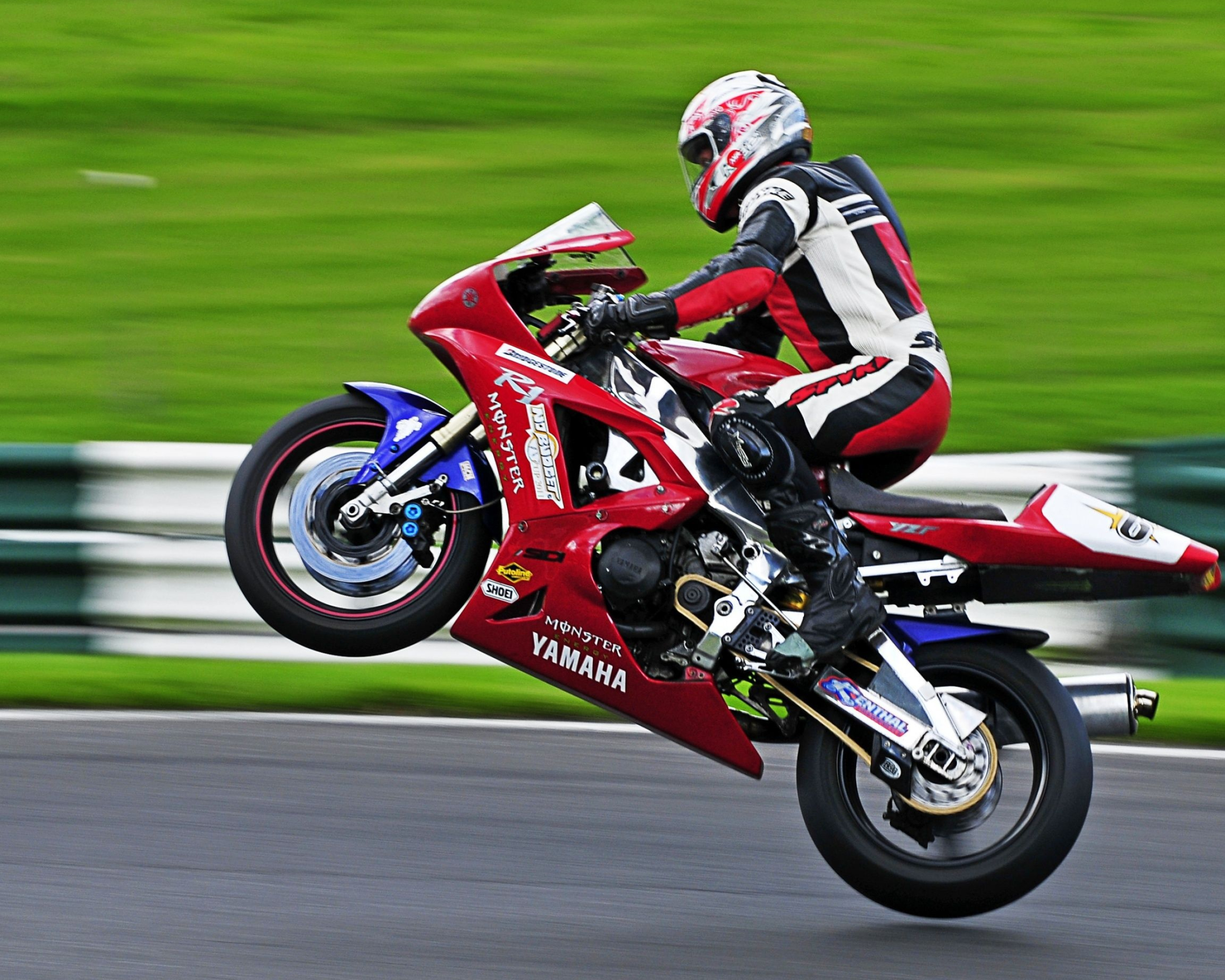 Motorcycle Racing: Wheelie Trick On a High Speed, Masterful Performance of a Motoracer. 2560x2050 HD Background.