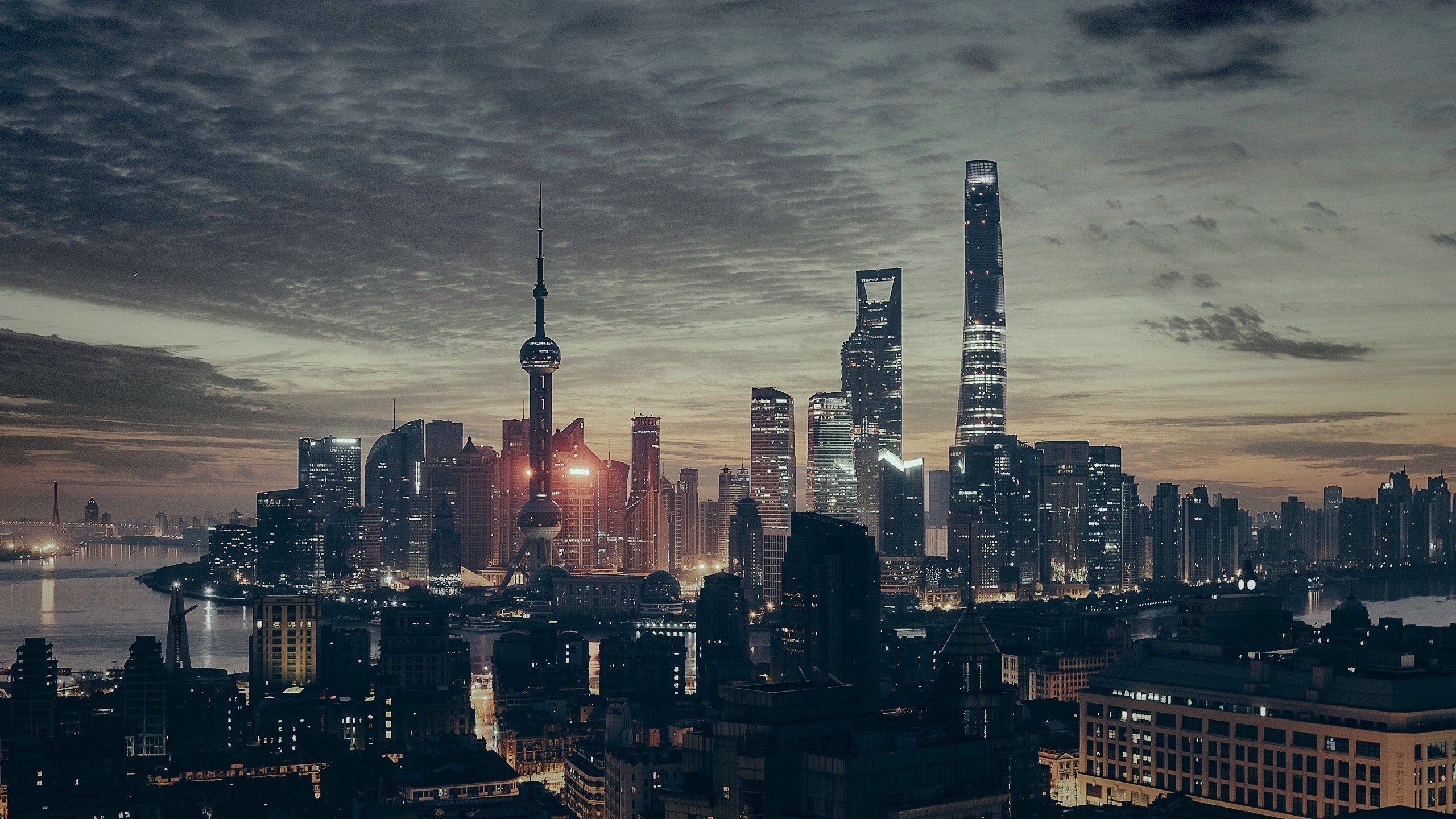 Cityscape: Lujiazui district in Shanghai, A peninsula formed by a bend in the Huangpu River, Central business area. 2560x1440 HD Background.