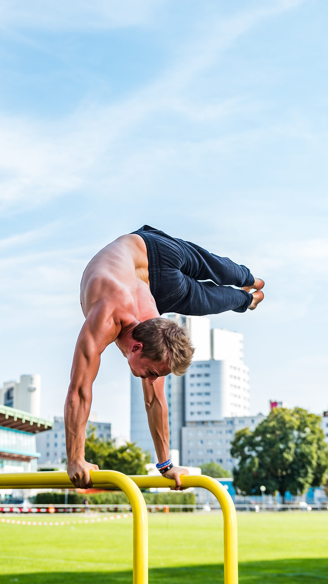 Calisthenics: An advanced handstand with a stretch, Action sports. 1350x2400 HD Background.