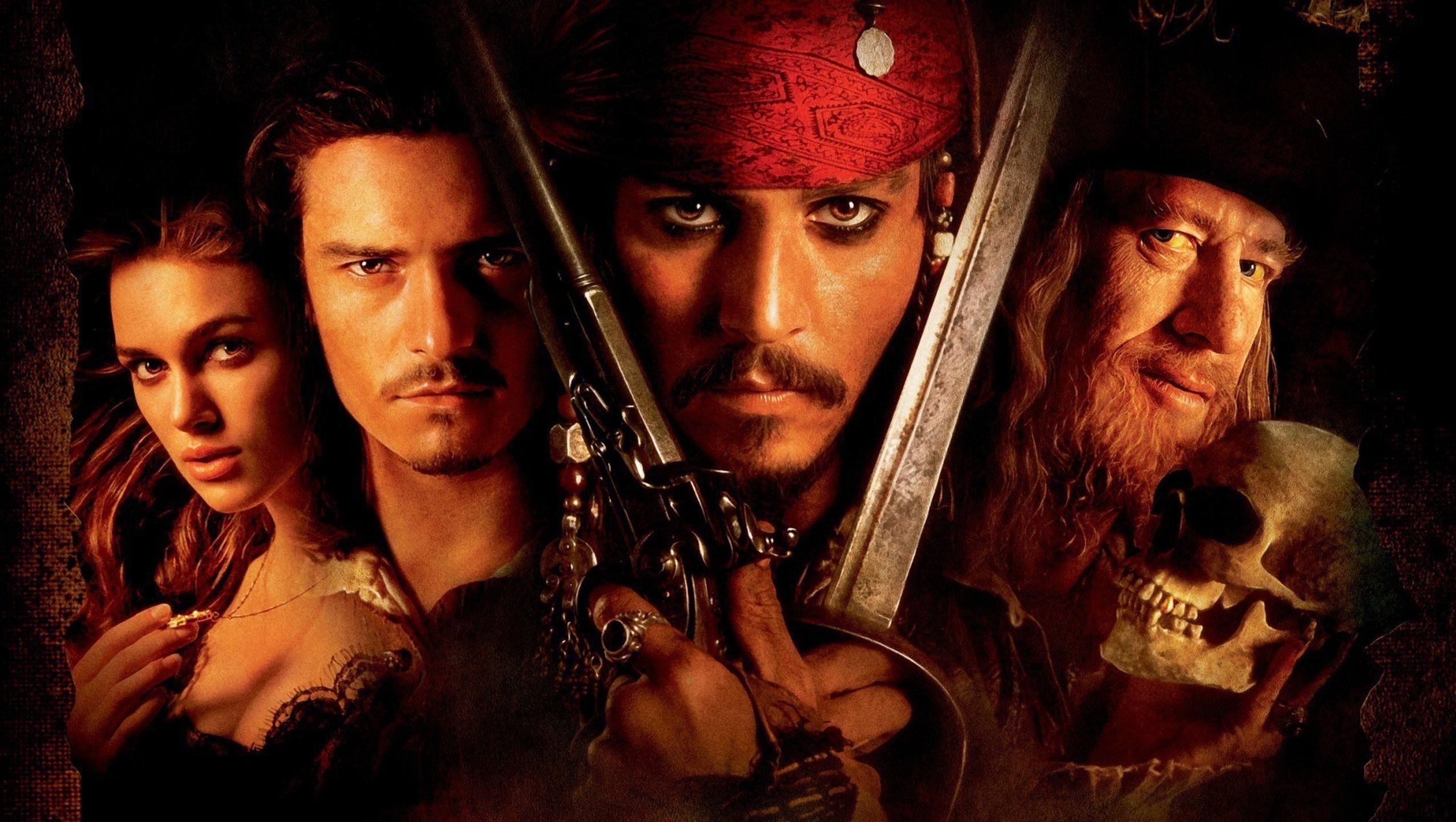 Pirates of the Caribbean: The Curse of the Black Pearl, Jack Sparrow (Johnny Depp) and blacksmith Will Turner (Orlando Bloom). 2560x1450 HD Wallpaper.