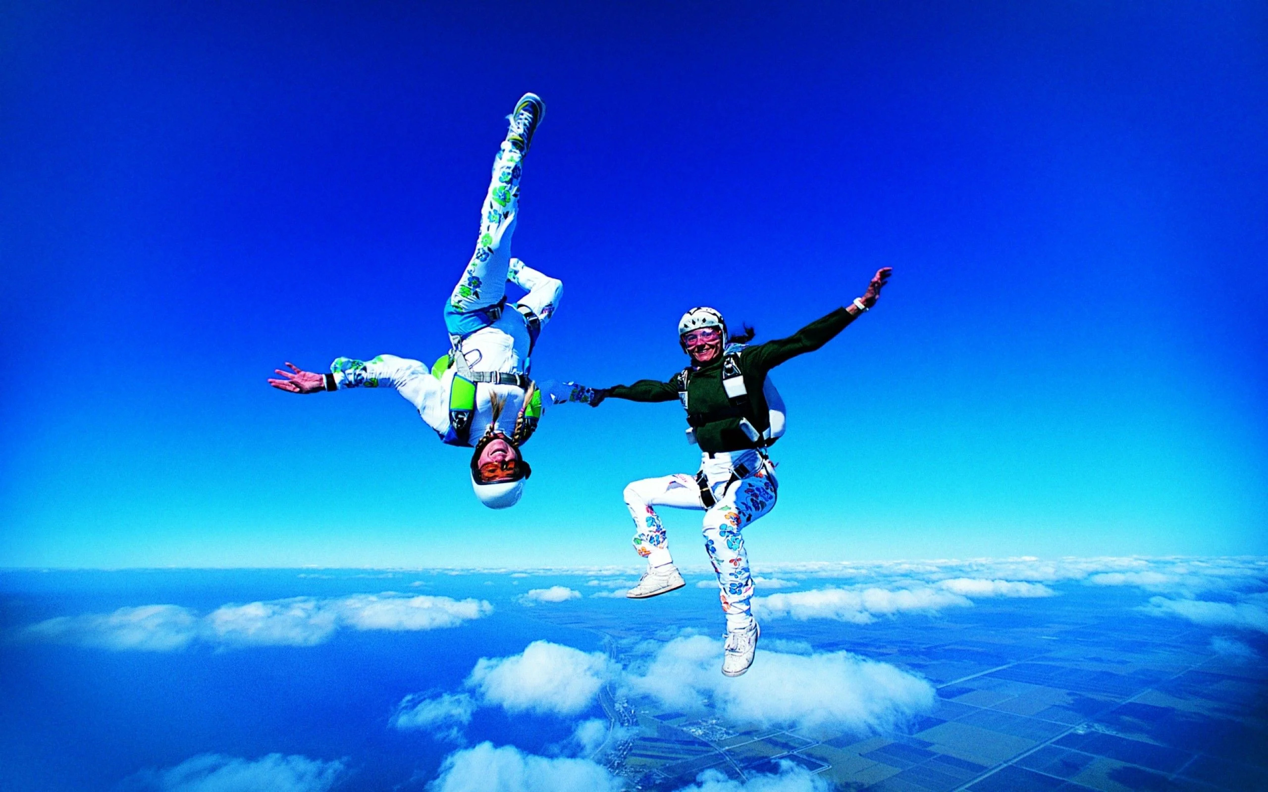 Parachuting: Aerobatics elements during free-falling, Tandem skydiving. 2560x1600 HD Background.