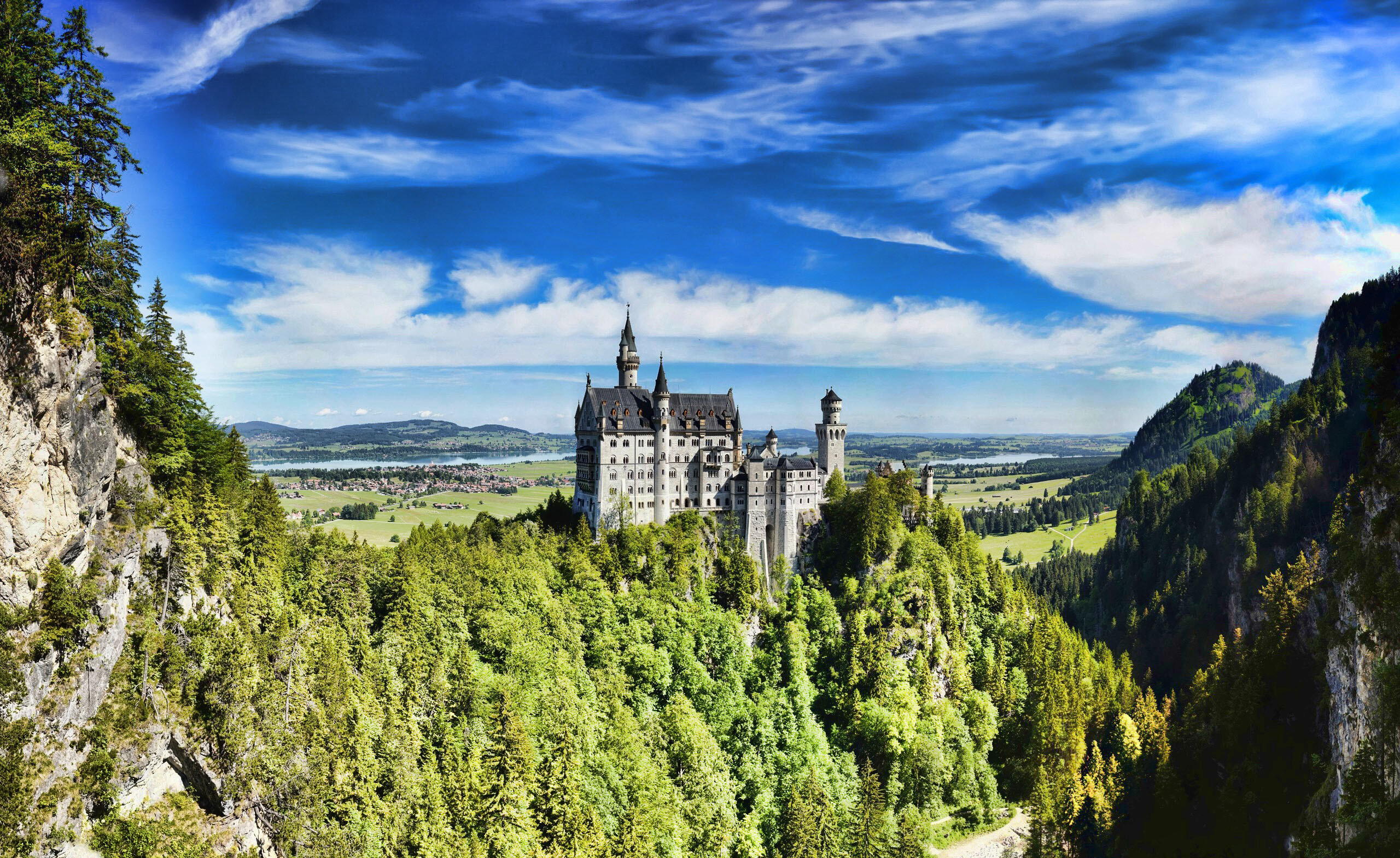 Neuschwanstein Castle: A fortified structure built during the Middle Ages, Bavaria. 2560x1570 HD Wallpaper.