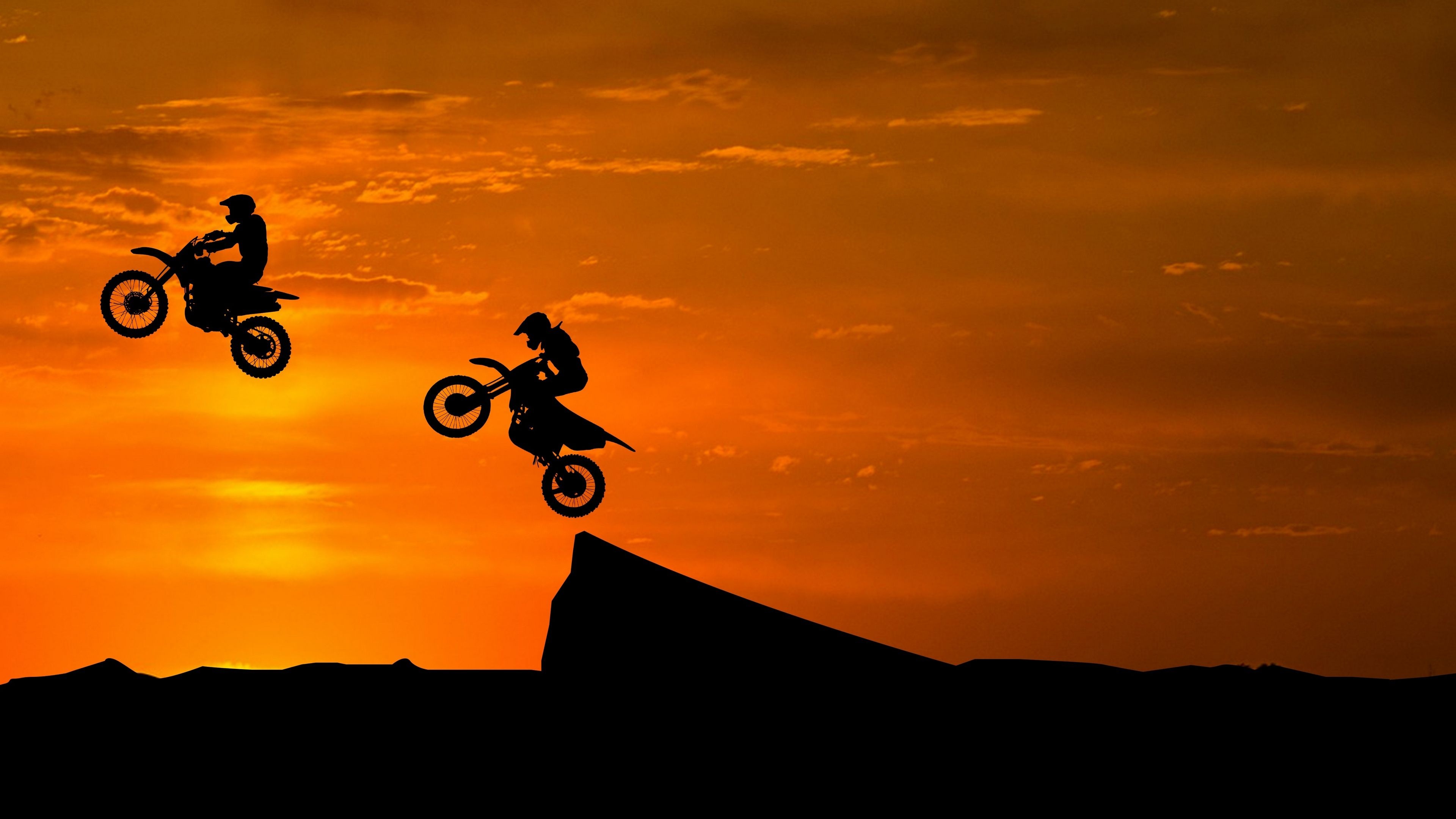 Stunt: Motocross in a group, Risky sport on dirt bikes, Motorcycle stunt riding. 3840x2160 4K Background.