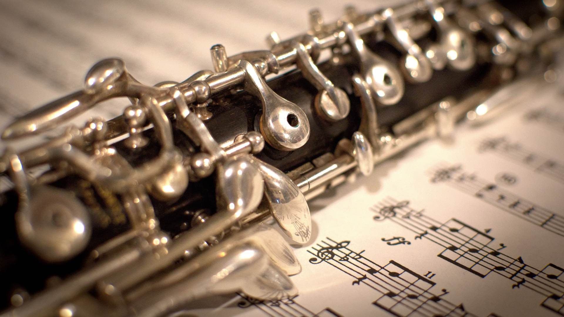 Oboe: A woodwind instrument having a slender conical tubular body and a double-reed mouthpiece. 1920x1080 Full HD Background.