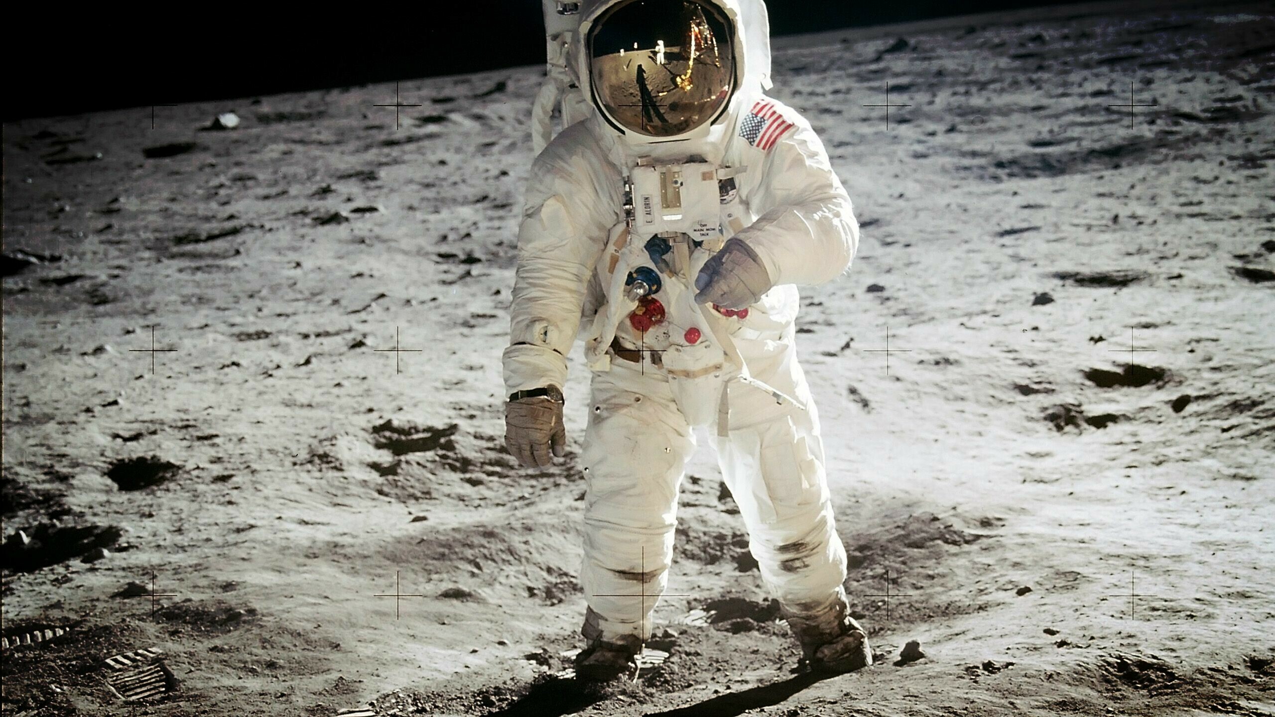 Man on the Moon: Neil Armstrong and Buzz Aldrin landed the Apollo Lunar Module Eagle on July 20, 1969. 2560x1440 HD Background.