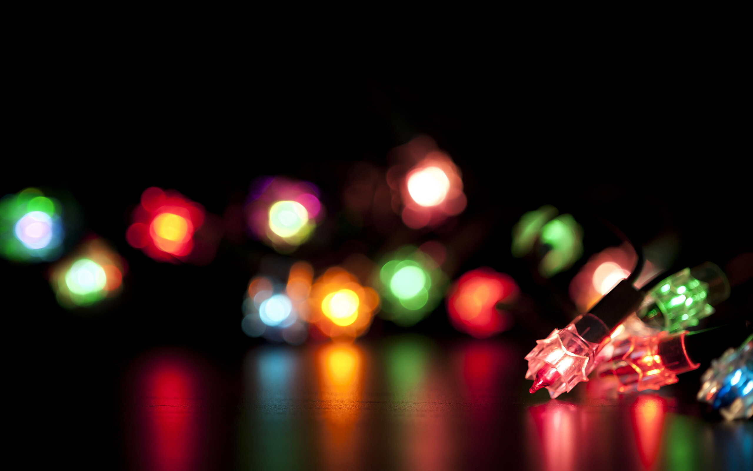 Christmas Lights: Small colored electric bulbs strung together and used for decoration. 2560x1600 HD Background.
