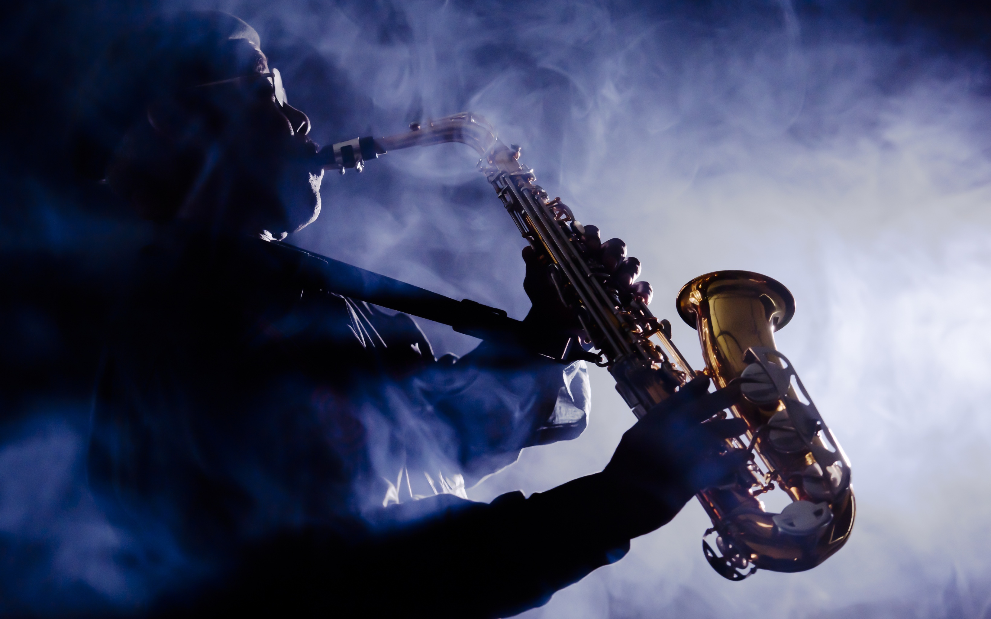 Saxophone: A single-reed woodwind instrument characterized by a conical metal tube and finger keys. 3280x2050 HD Background.