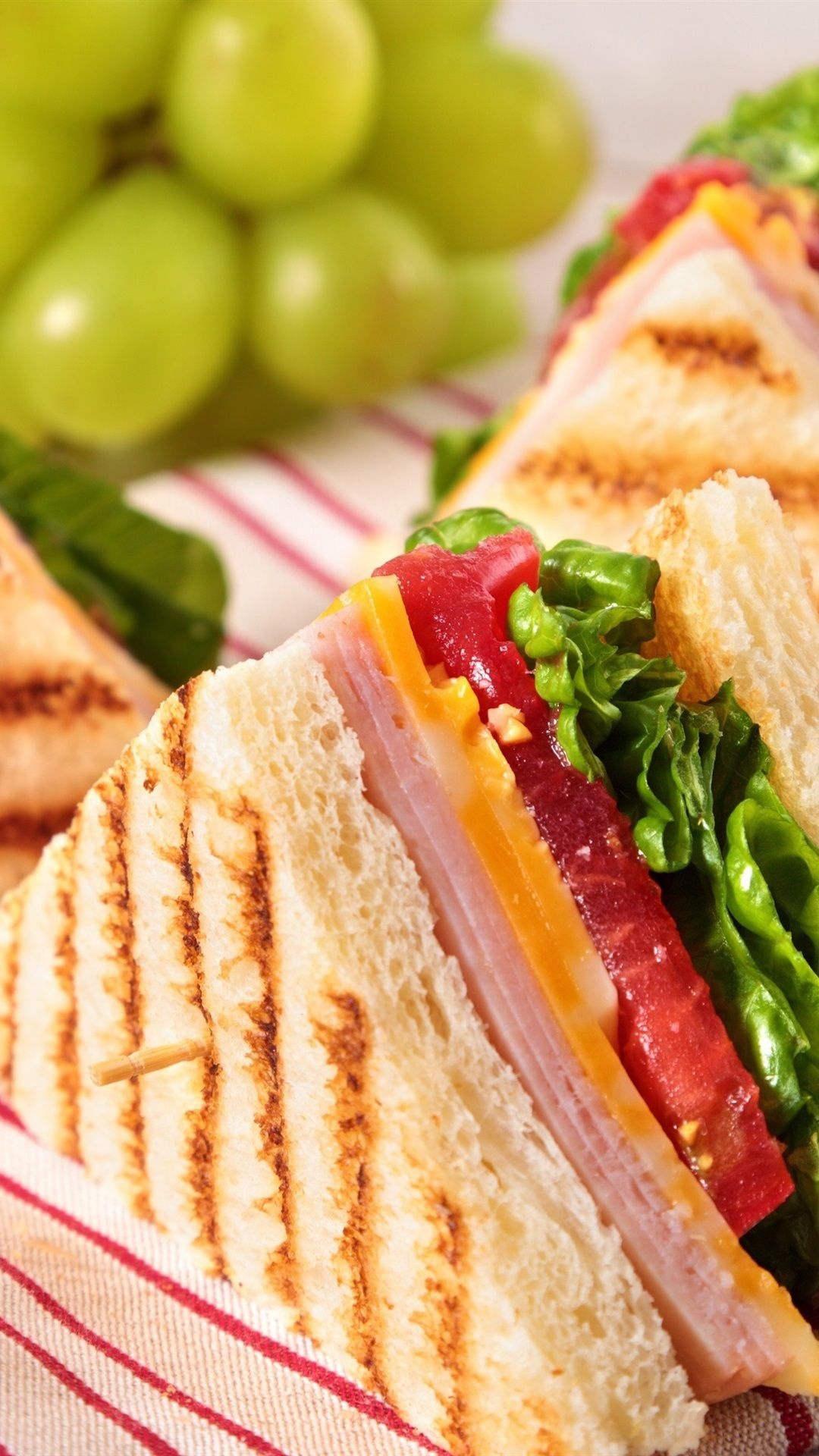 Sandwich: The bread is cut horizontally and filled with deli ingredients. 1080x1920 Full HD Background.