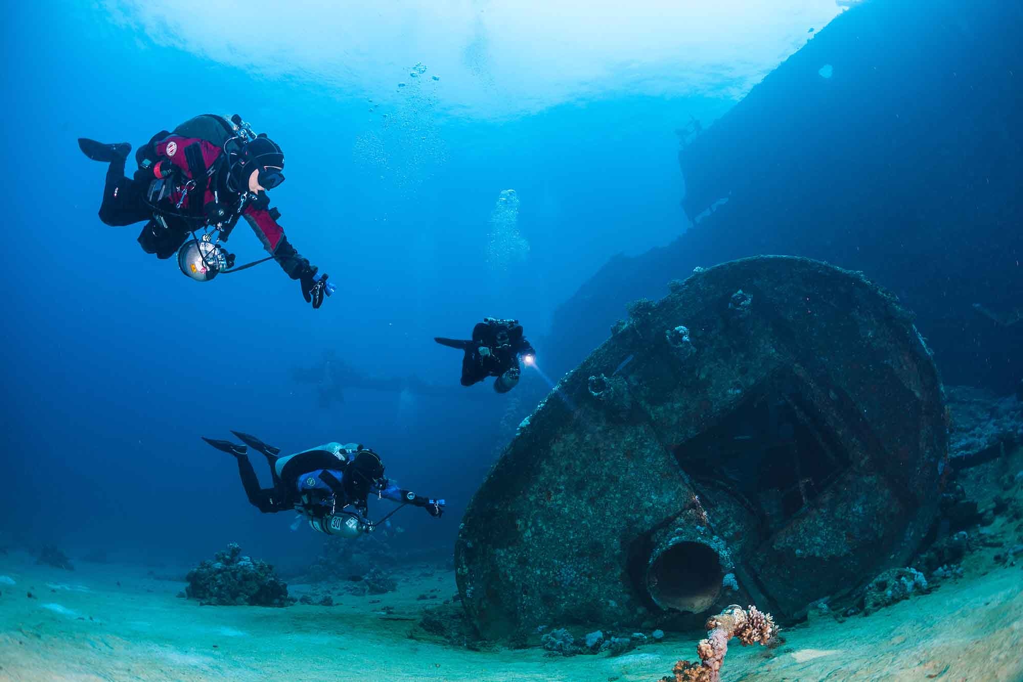 Diving: A group of divers explores a wrecked ship, Adventurous underwater activity. 2000x1340 HD Wallpaper.