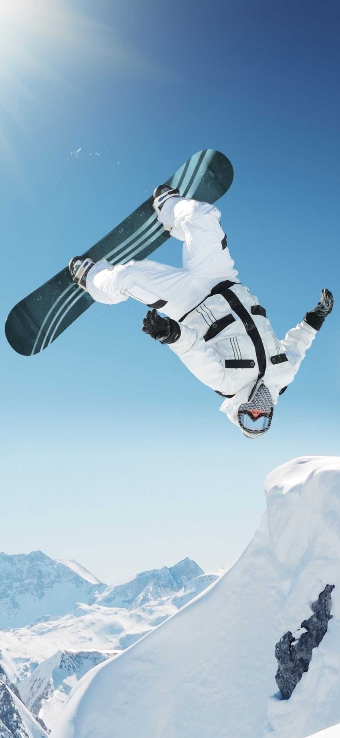 Snowboarding: Backflip trick in the air, Extreme alpine snowboarding, Winter performance sport. 1130x2440 HD Wallpaper.