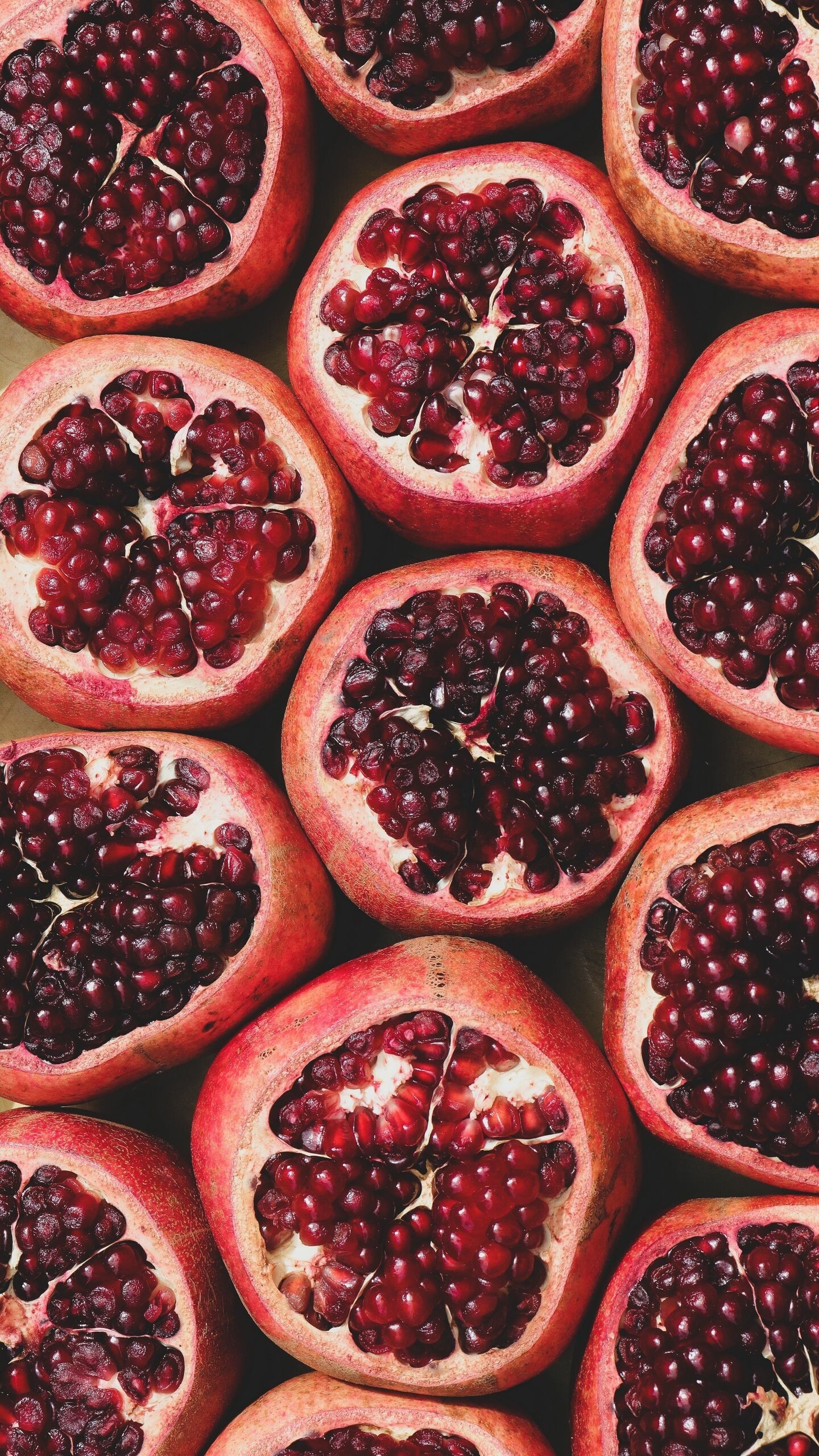 Fruit: Pomegranate, Round, reddish-brown fruits with a hard, smooth exterior. 1440x2560 HD Background.