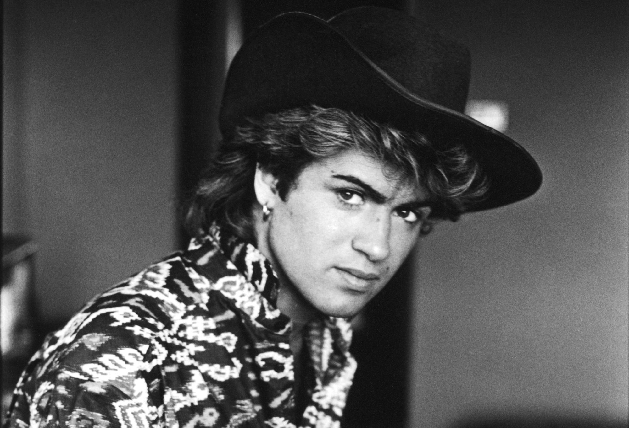 George Michael: Began his career as one half of the duo Wham! along with Andrew Ridgeley and went on to establish a solo career as a soul-influenced pop musician, Black-and-white. 2000x1370 HD Wallpaper.
