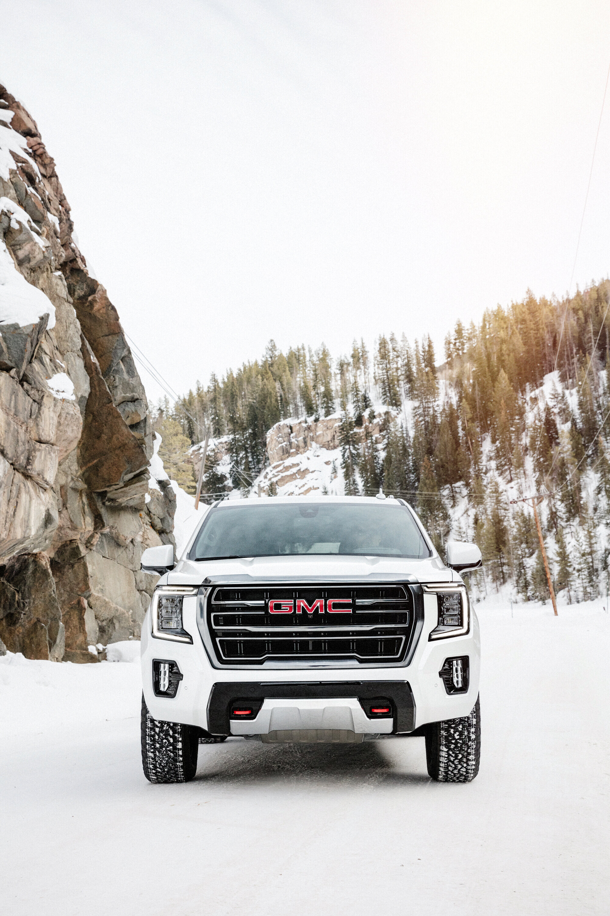 GMC: Yukon AT4, An off-road-ready exterior, Driving on the snow. 2000x3000 HD Wallpaper.