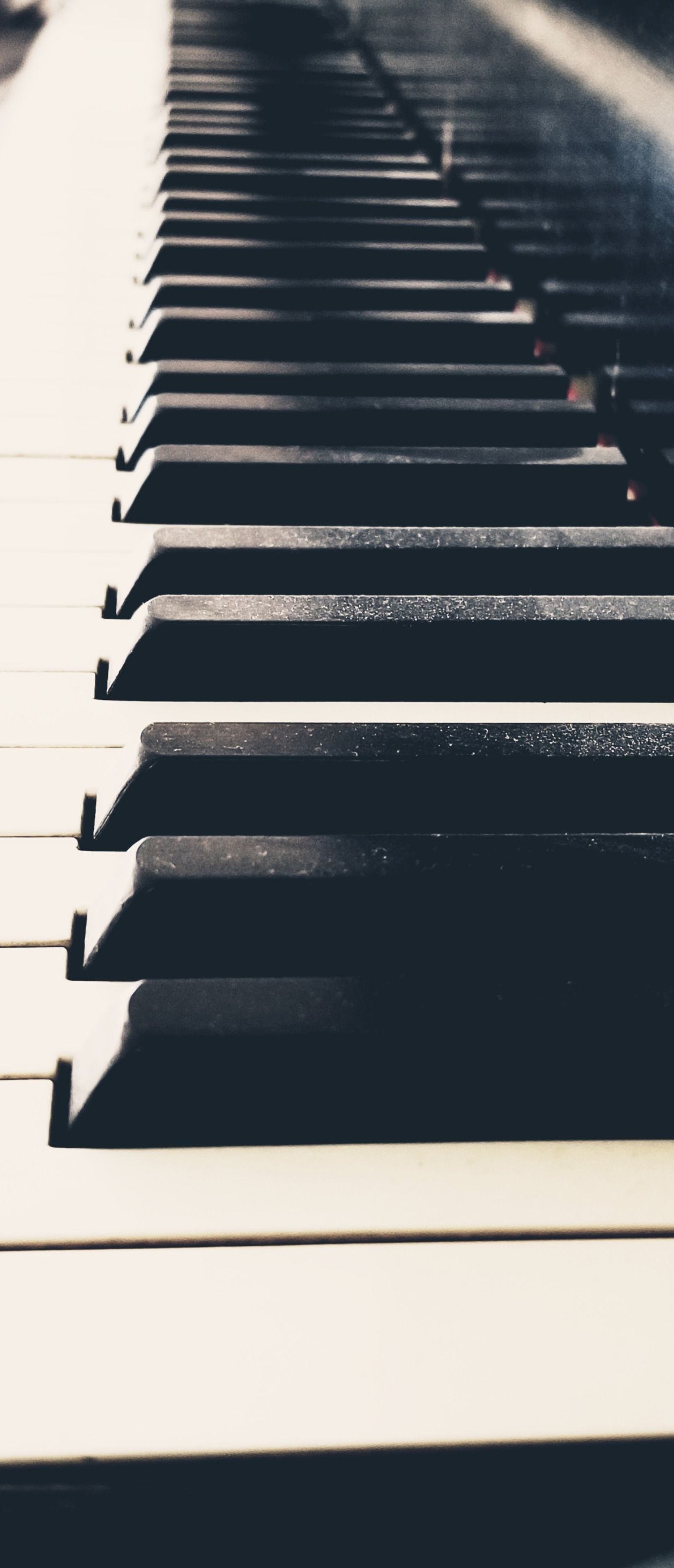Grand Piano: A stringed keyboard musical instrument with a row of 88 black and white keys. 1370x3170 HD Background.