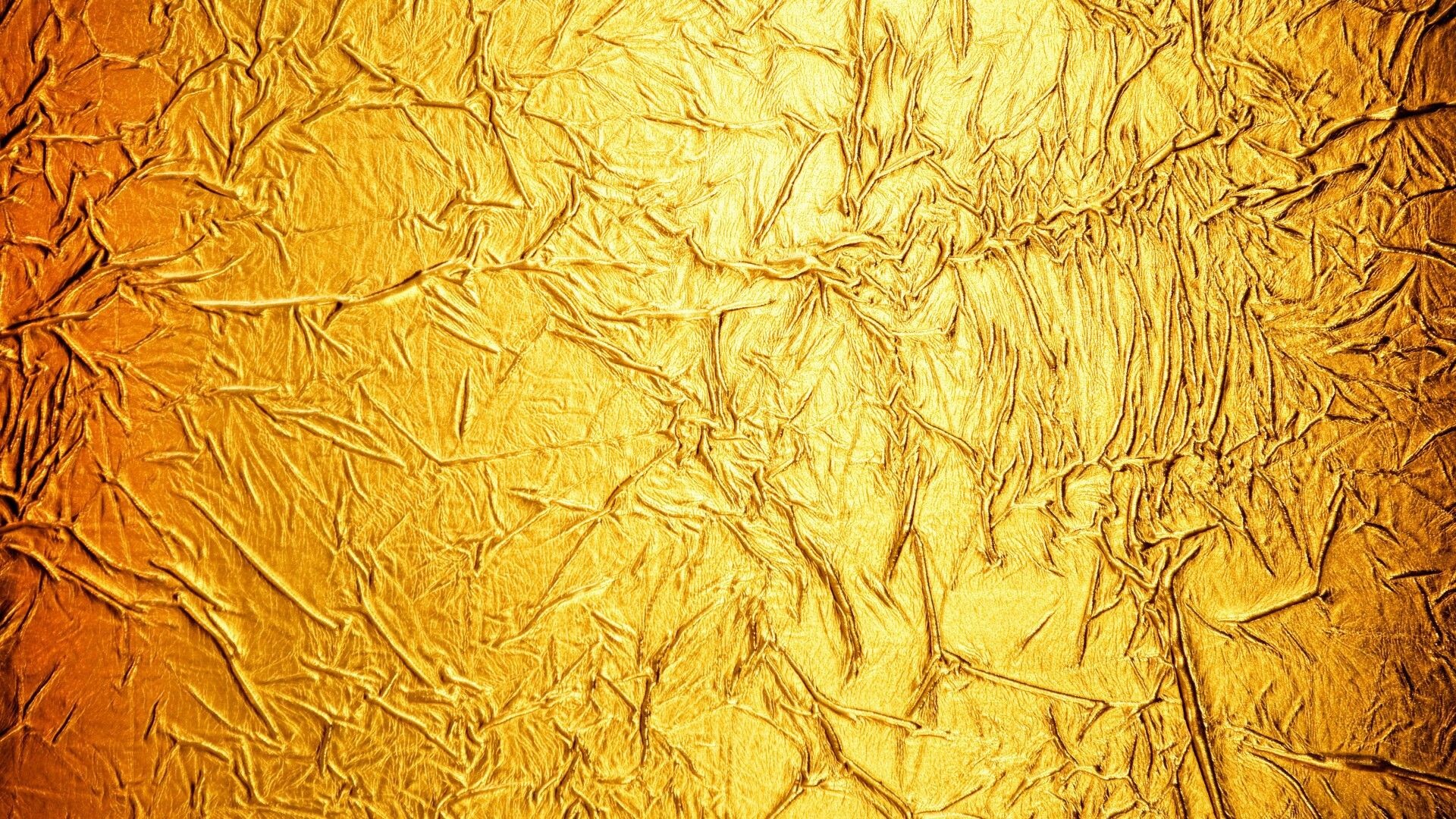 Gold Foil: The thin reddish yellow sheet used by decorators for centuries. 1920x1080 Full HD Background.