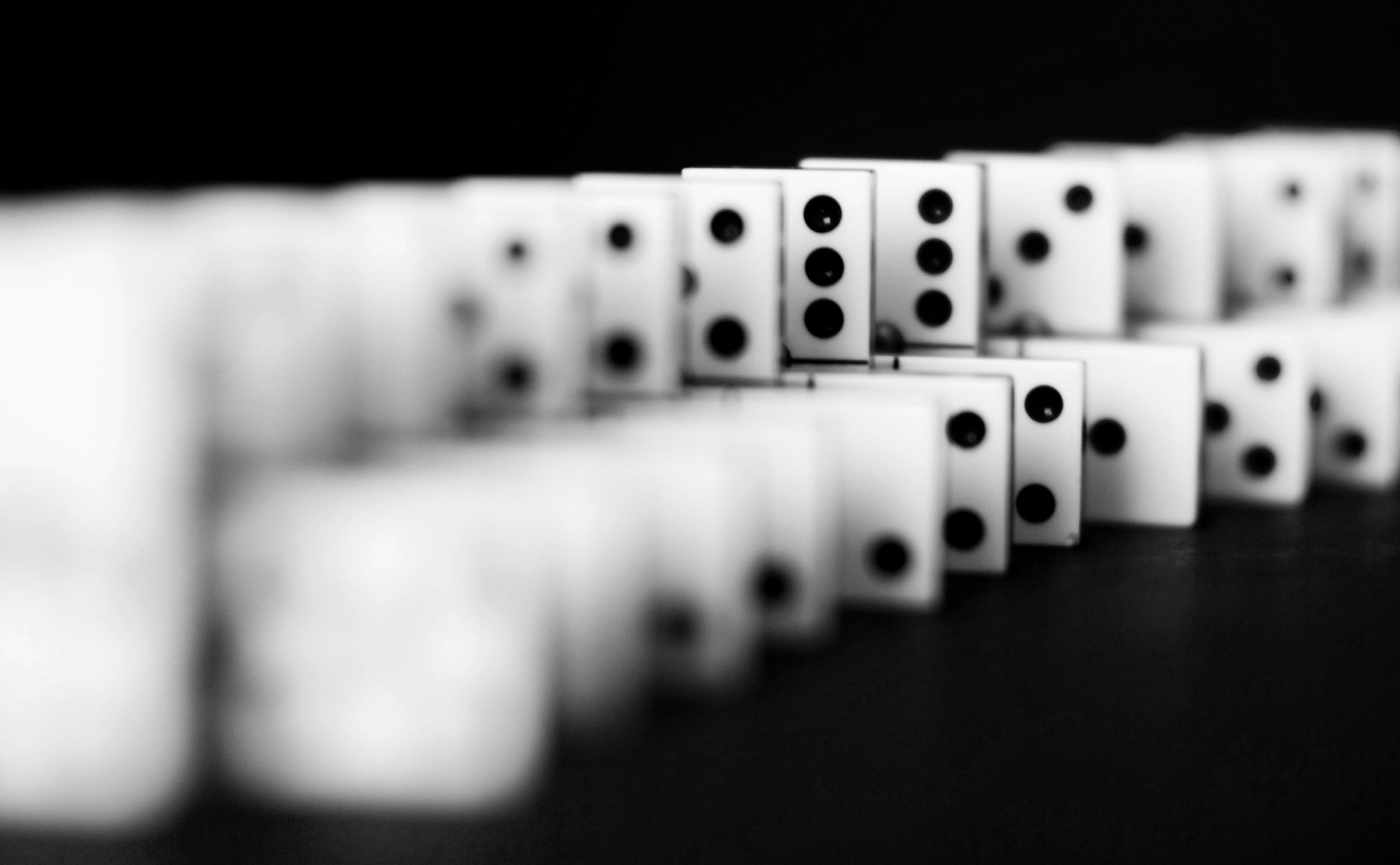 Dominoes: Modern white tile doubles, A row formation built with small rectangular gaming bones, Monochromic. 2410x1490 HD Background.