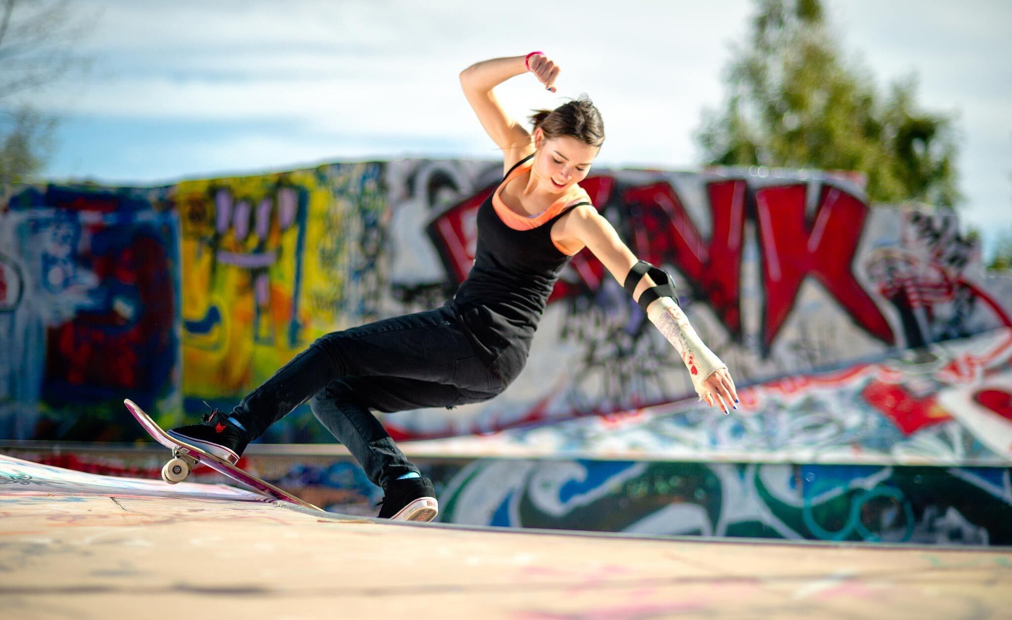 Girl Skateboarding: A skateboarder in mid-flight performing a trick, Freestyle maneuvers, Female skateboard collective. 2050x1260 HD Wallpaper.