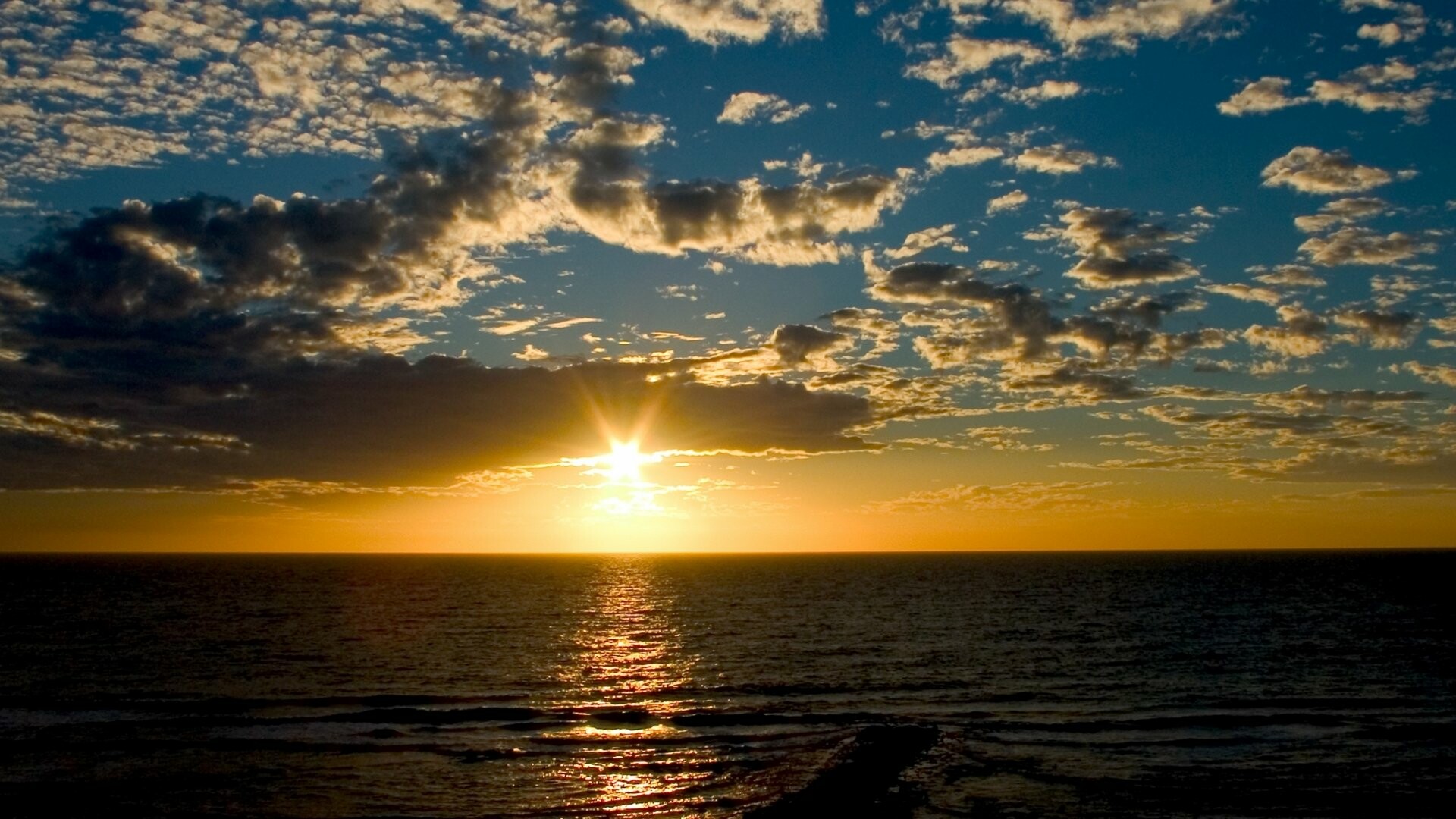 Sunrise: The morning twilight, The sun breaking through a dark-bottomed cloud. 1920x1080 Full HD Wallpaper.