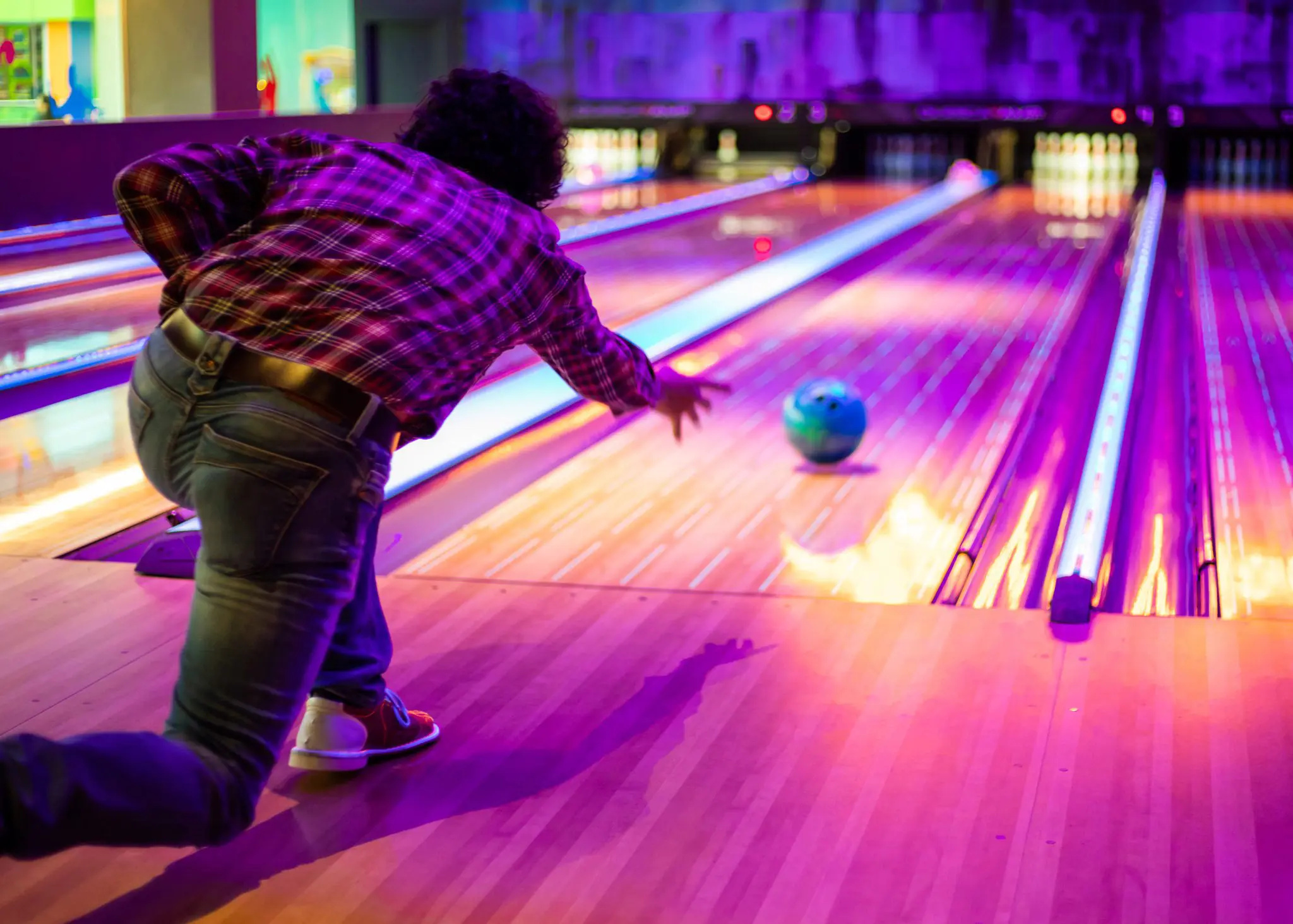 Bowling: A game which goal is to knock over pins on a long playing surface. 2050x1470 HD Background.