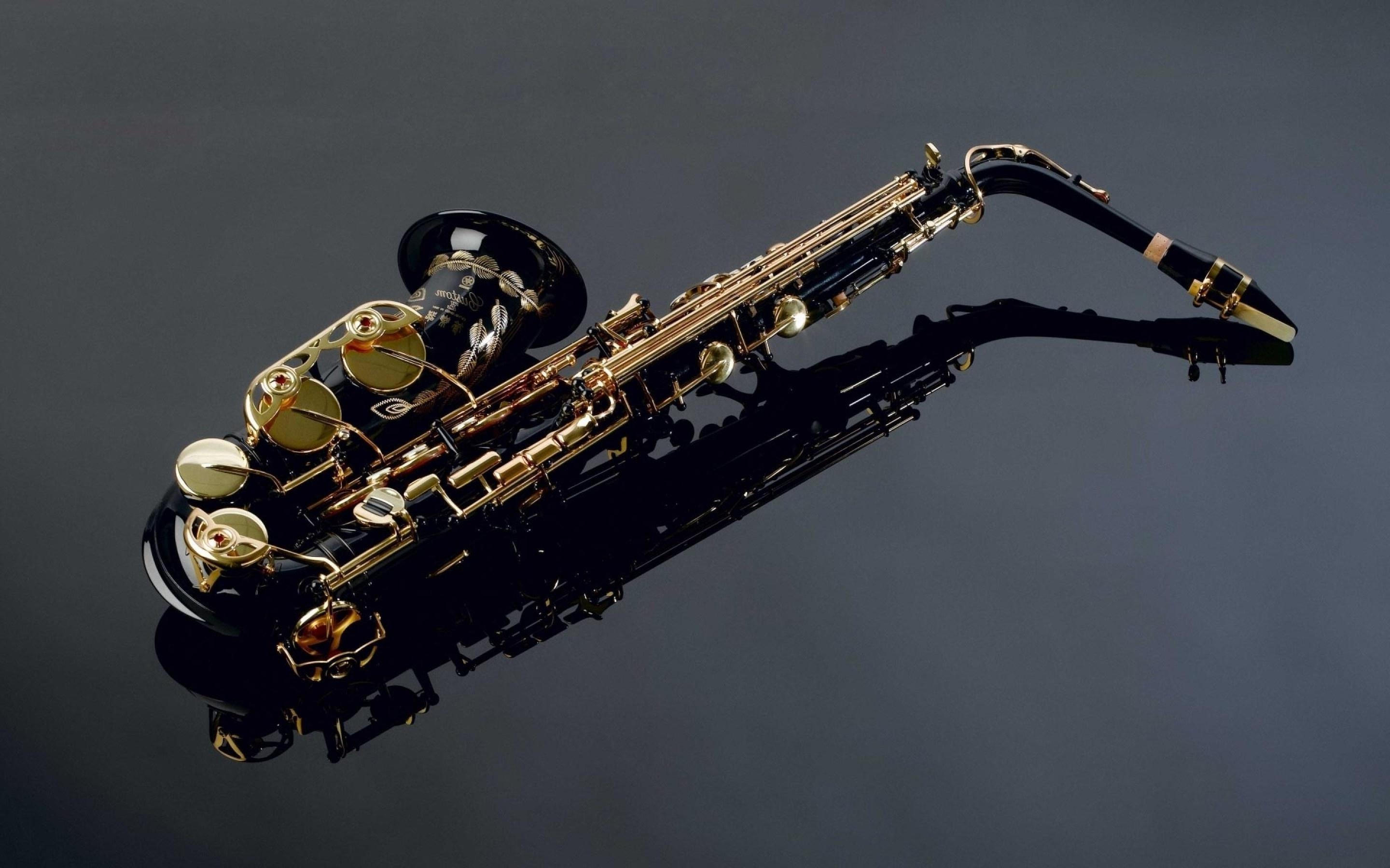 Saxophone: A brass instrument played by blowing into a mouthpiece and pressing keys to form musical notes. 2880x1800 HD Wallpaper.