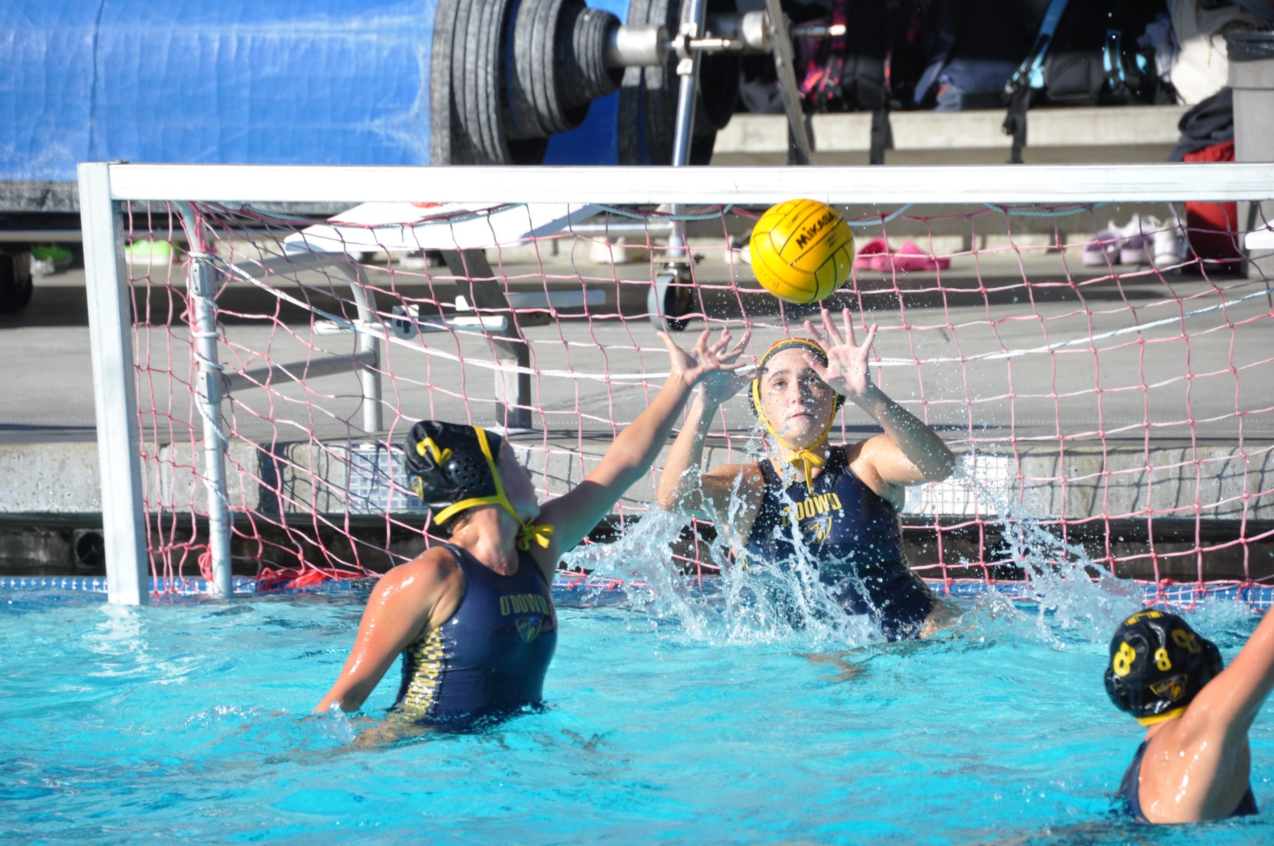 Water Polo: A goalkeeper catches a ball, Bishop O'Dowd High School women's team training event. 2560x1700 HD Wallpaper.
