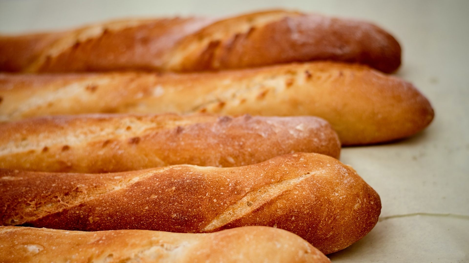 Baguette: Known for its crackly, crispy crust and pillowy chew. 1920x1080 Full HD Background.