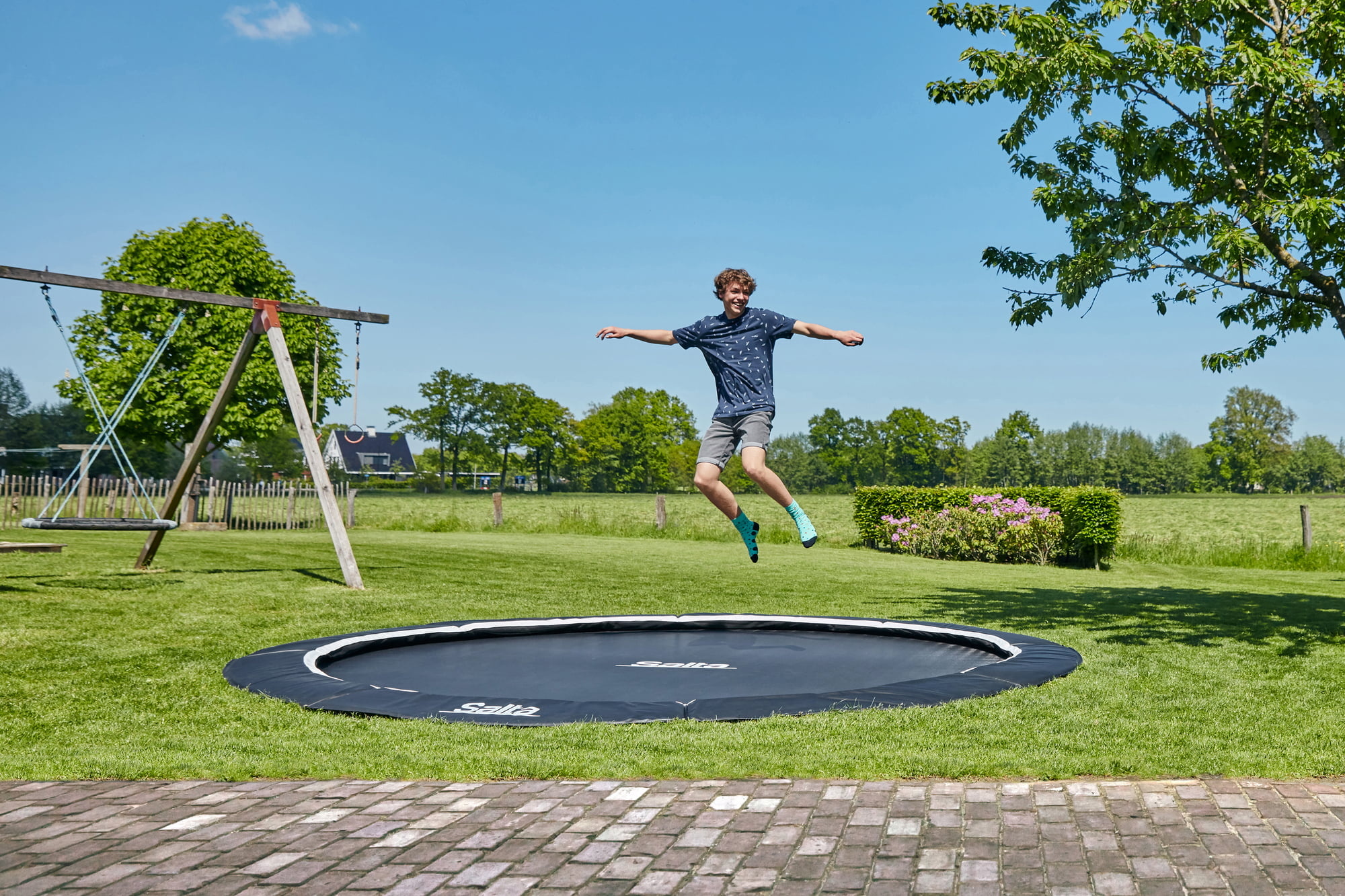 Trampolining: A jumper performs acrobatic tricks using the Salta Royal ground-based trampoline at the city park. 2000x1340 HD Wallpaper.