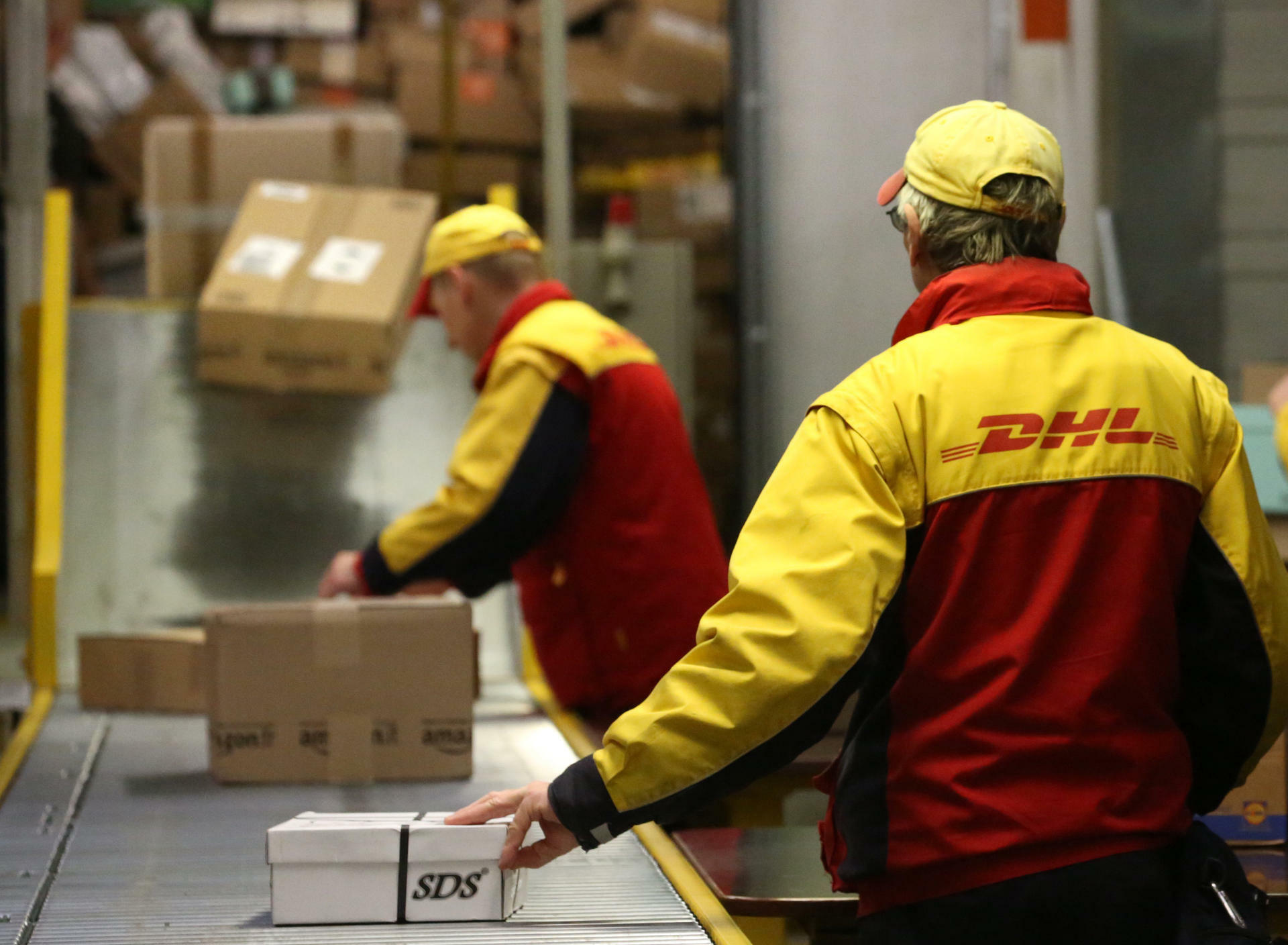 DHL: The company delivering over 1.6 billion parcels per year, International delivery. 1920x1410 HD Background.