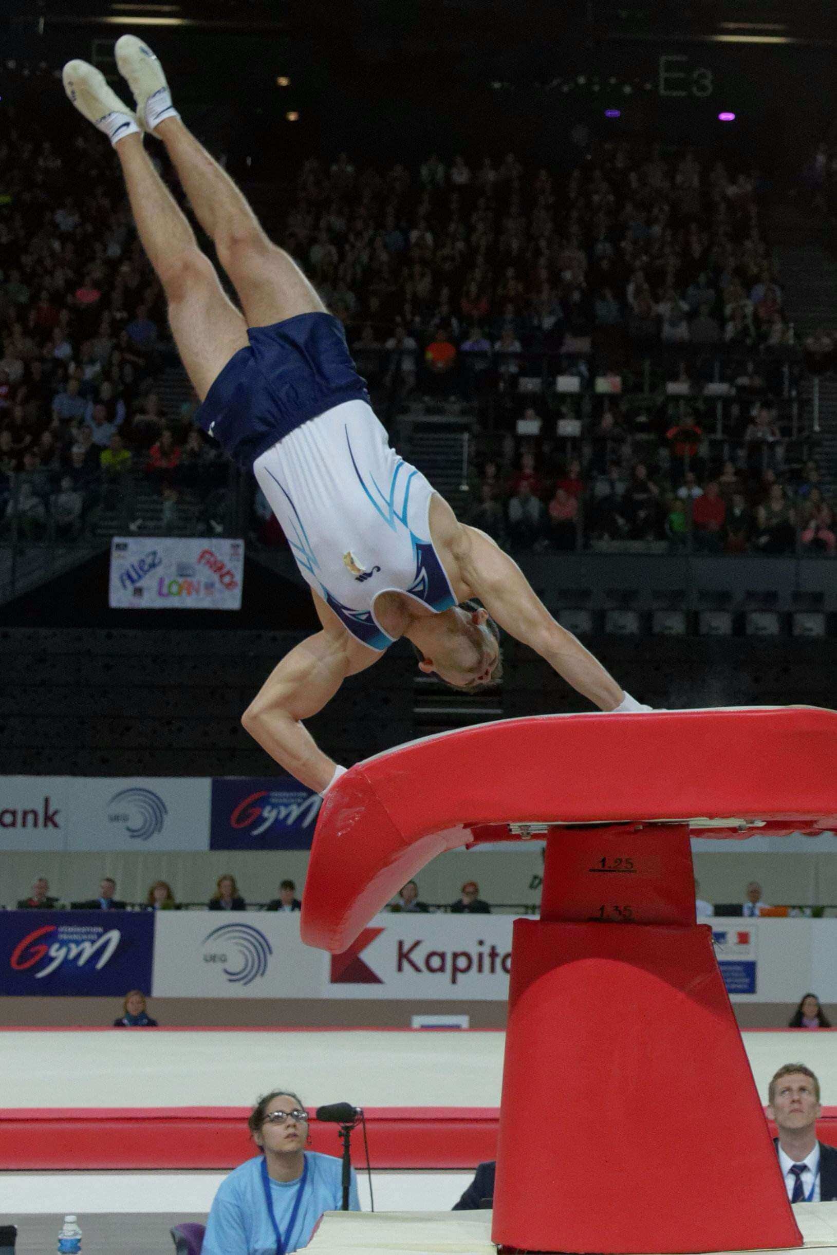Vault (Gymnastics): A male gymnast performs artistic choreography in the air during an event. 1630x2450 HD Wallpaper.