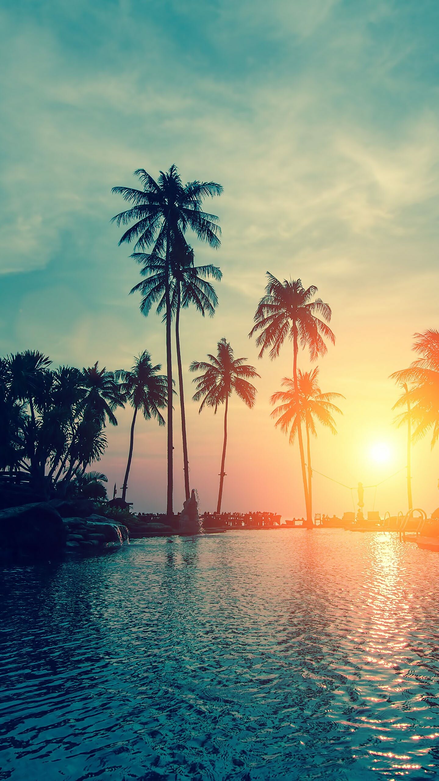 Palm tree silhouettes, Sunset paradise, Emerald sun, Serene atmosphere, 1440x2560 HD Phone