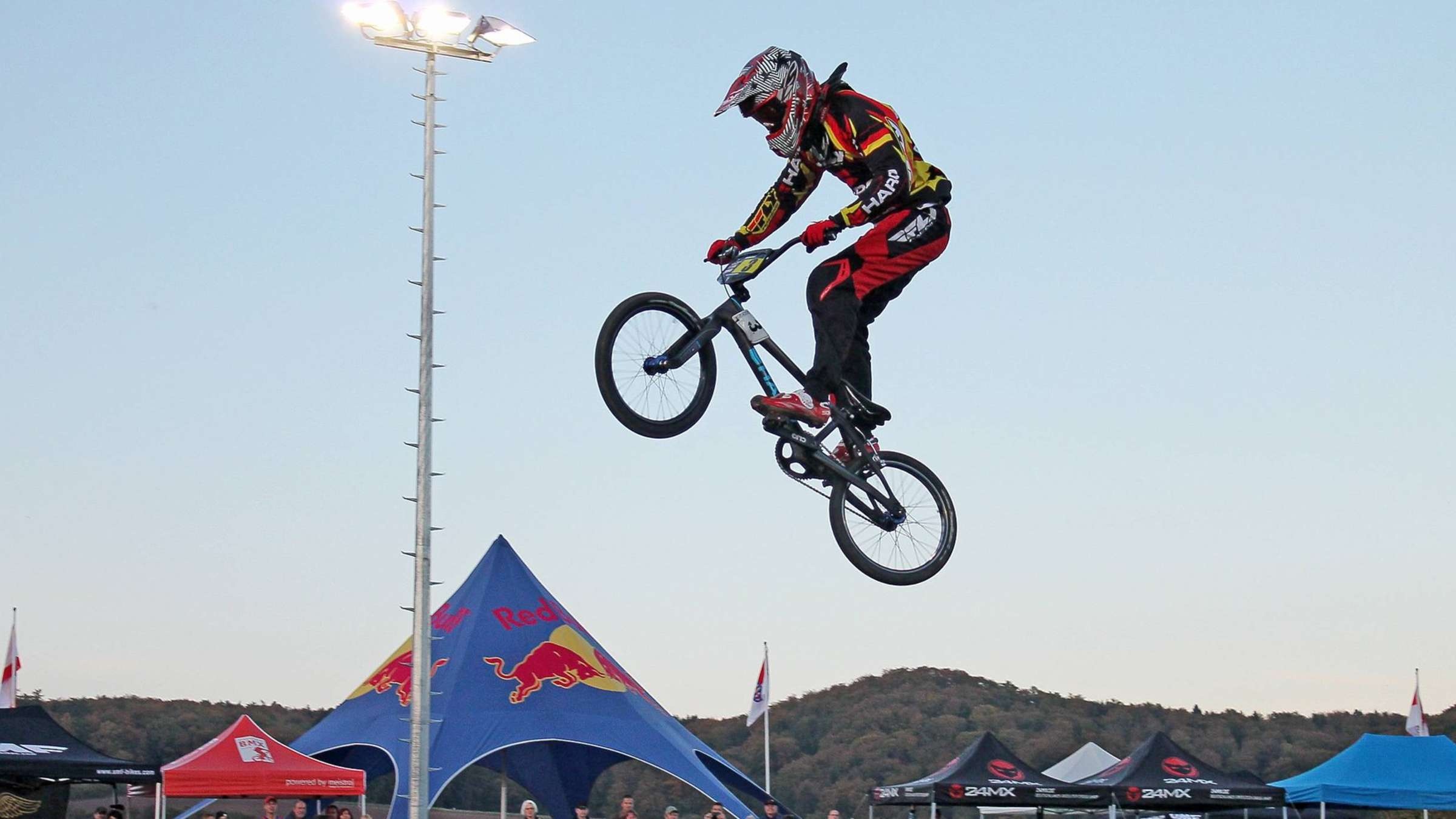 BMX (Sports): BMX Competition in Ahnatal, Athlete Takes Bicycle To The Air, Red Bull Tournament, Motocross Stunts. 2400x1350 HD Wallpaper.